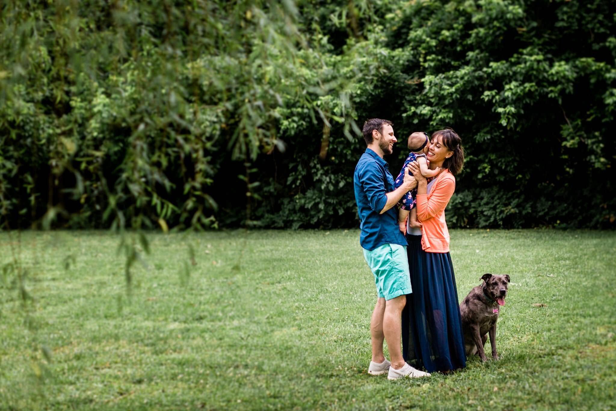 Raleigh Family Photographer | By G. Lin Photography | Family holding and hugging each other outside and laughing