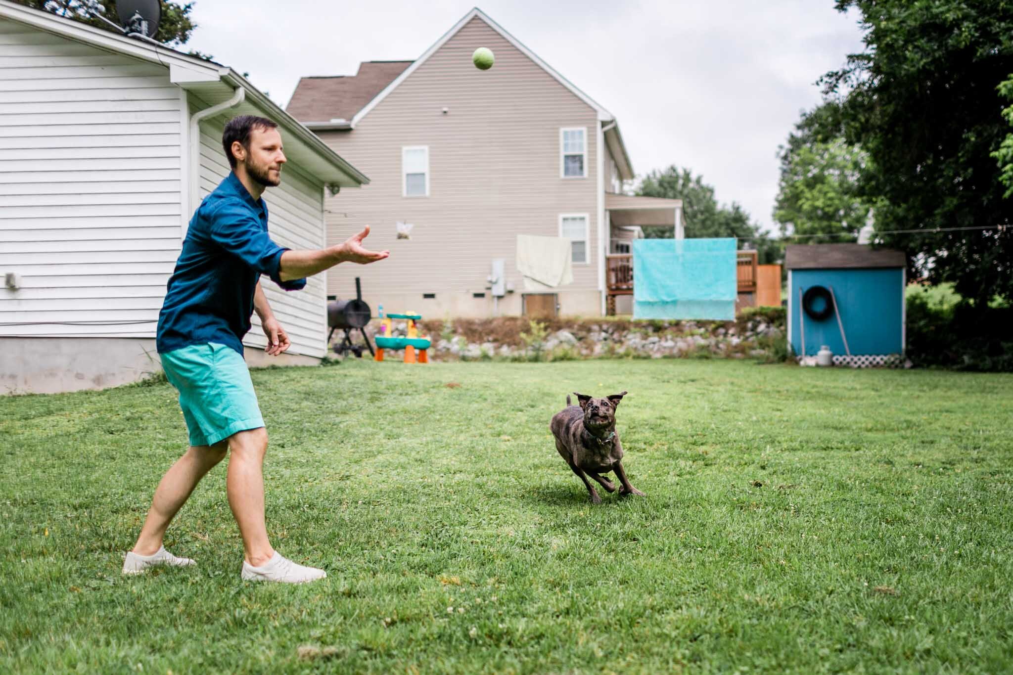 Raleigh Family Photographer | By G. Lin Photography | Man throwing ball in the air for dog