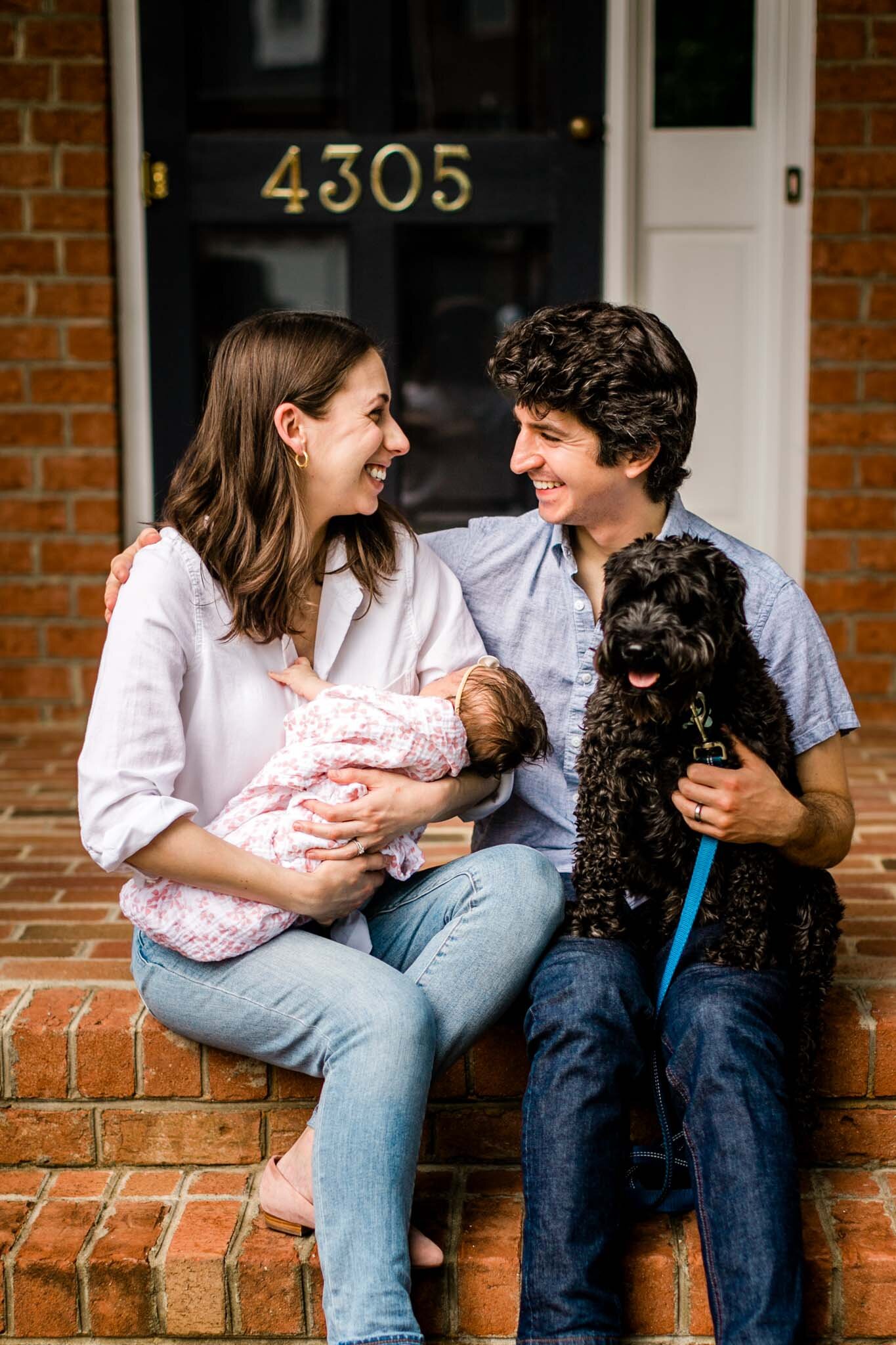 Durham Newborn Photographer | By G. Lin Photography | Mother and father looking at each other and smiling with baby