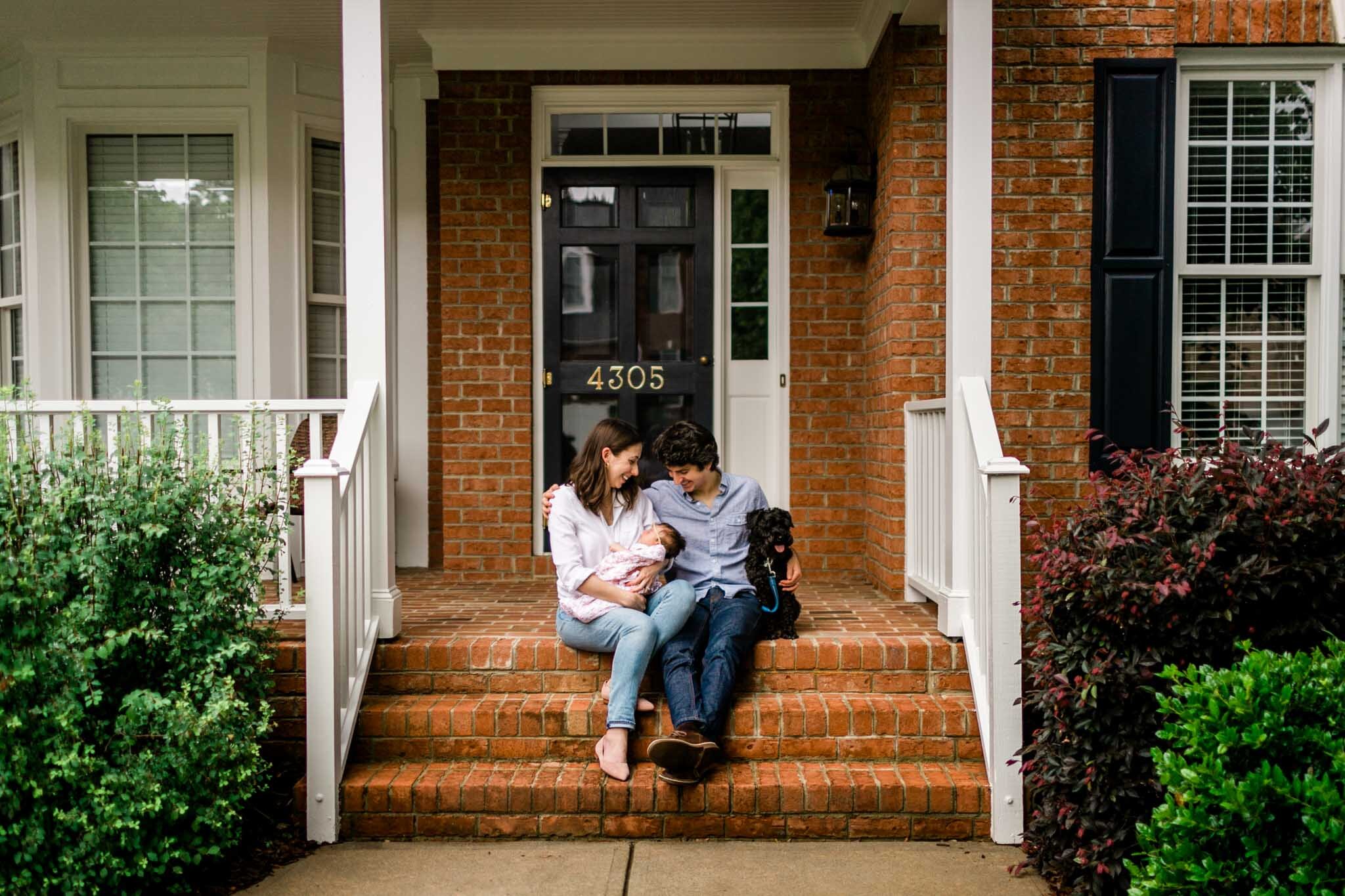 Durham Newborn Photographer | By G. Lin Photography | Porch portrait of new parents sitting in front of house steps
