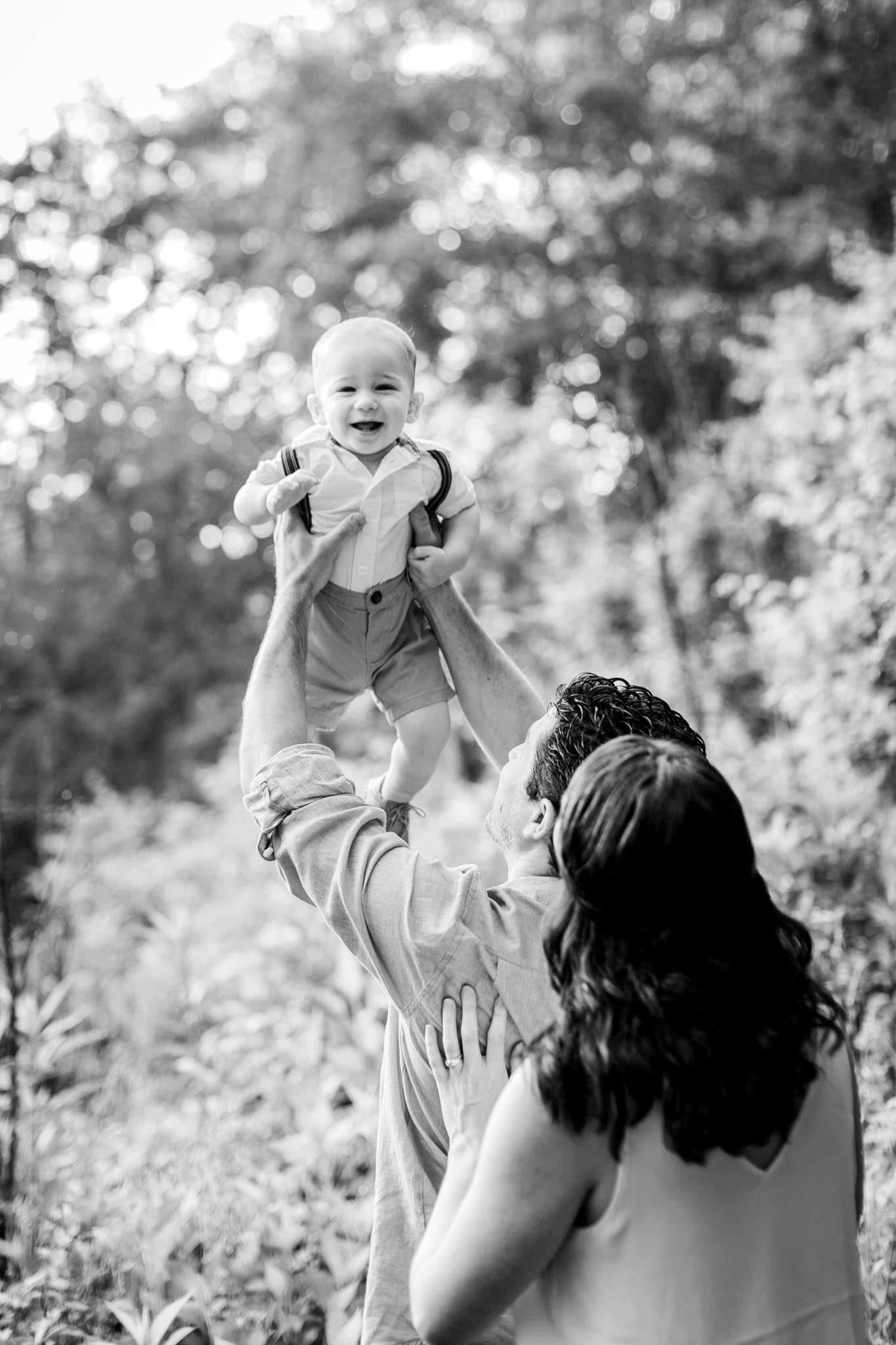 Raleigh Family Photographer | By G. Lin Photography | Baby boy laughing and being tossed up by parents