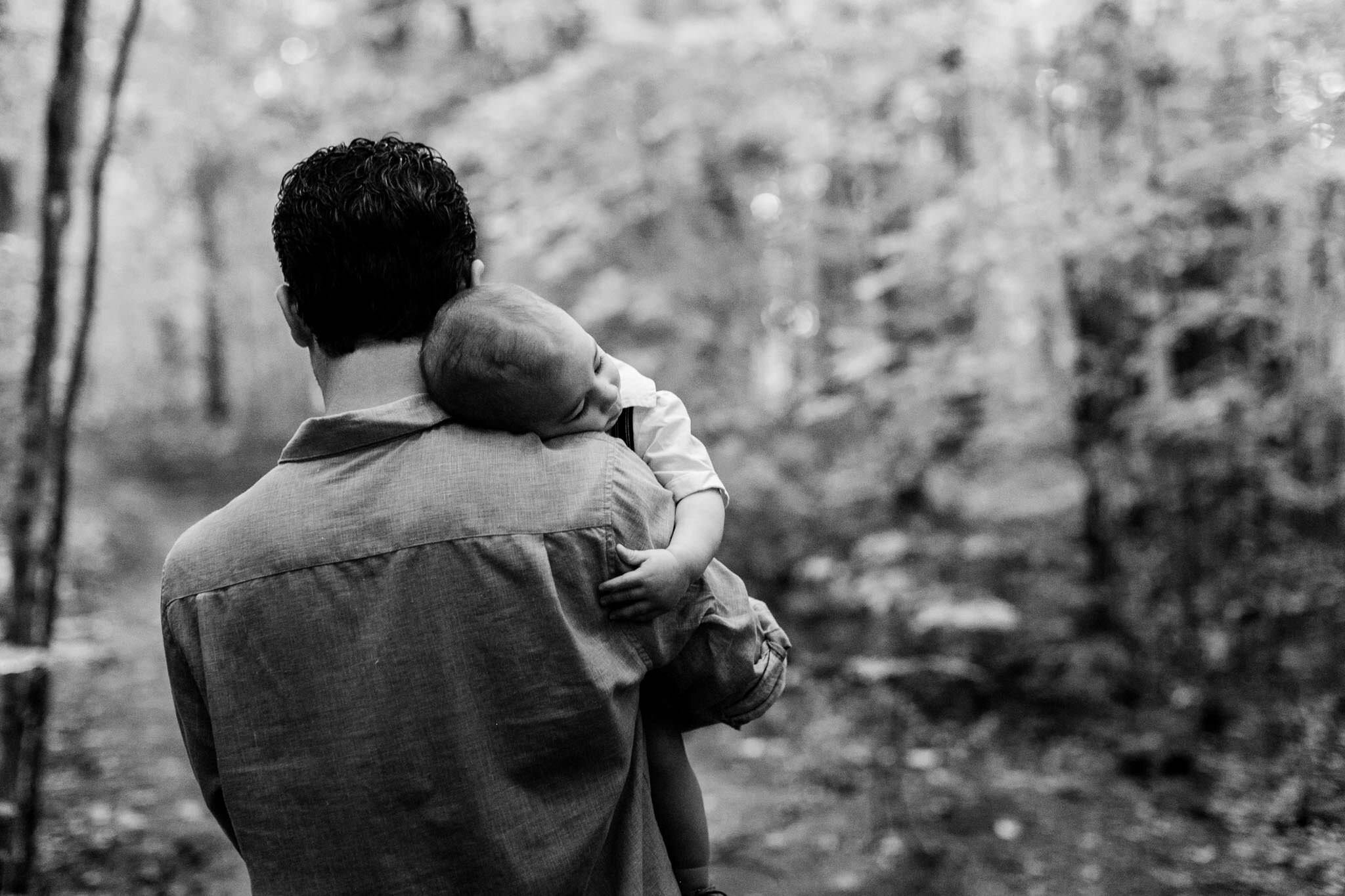 Raleigh Family Photographer | By G. Lin Photography | Father holding sleeping baby boy in arms