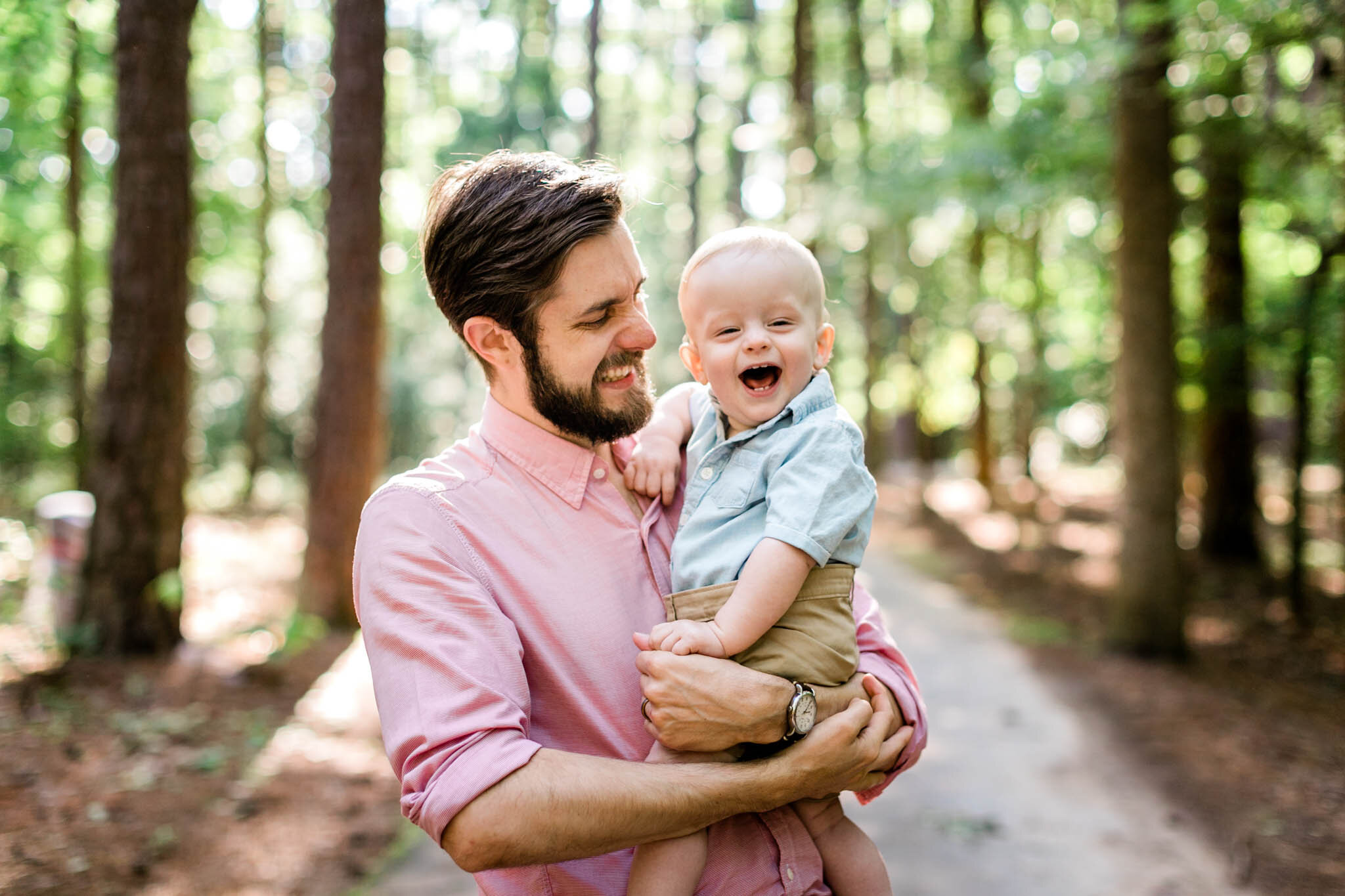 Raleigh Family Photographer | By G. Lin Photography | Umstead Park | Father holding baby son and laughing together