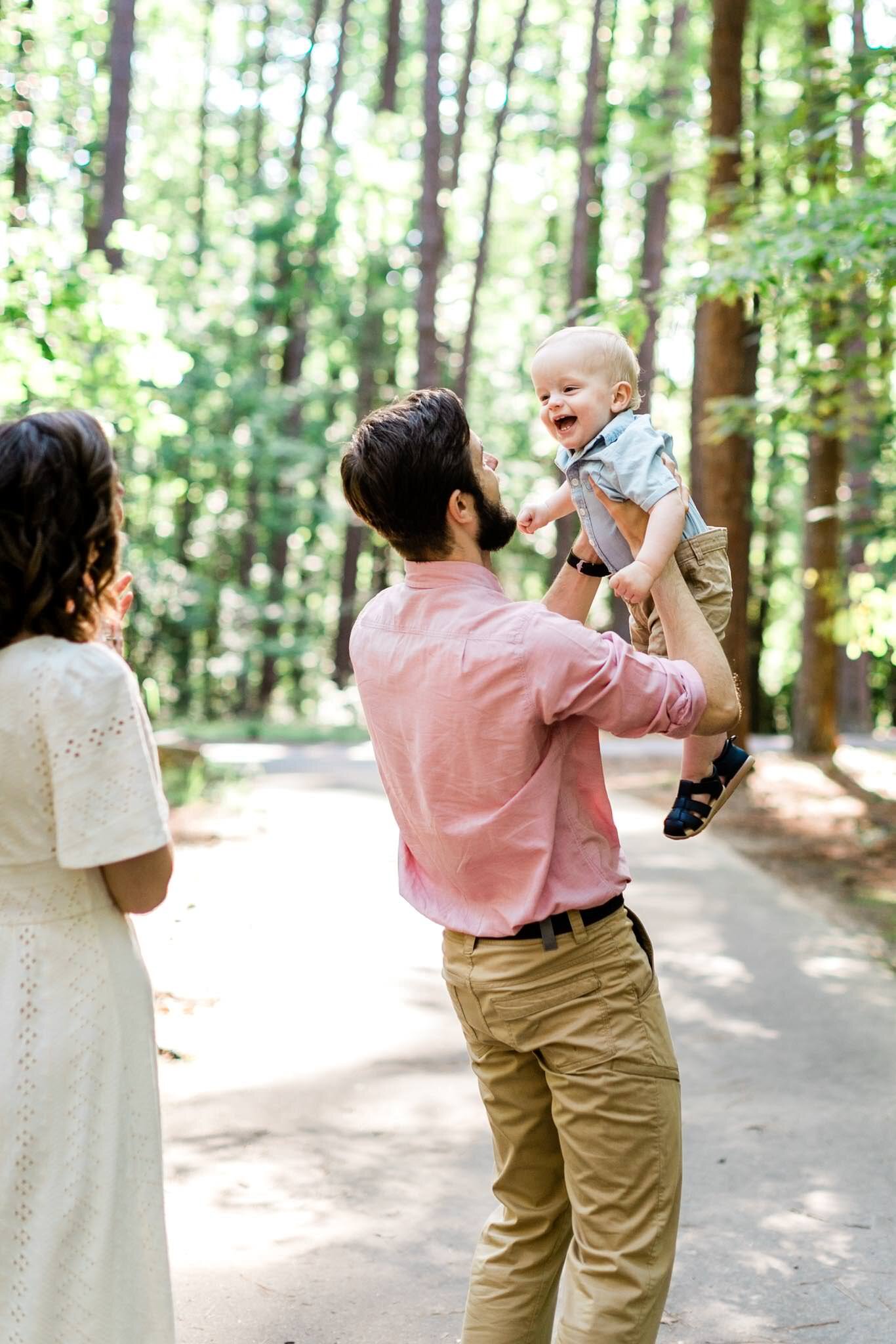 Raleigh Family Photographer | By G. Lin Photography | Umstead Park | Father holding son and laughing