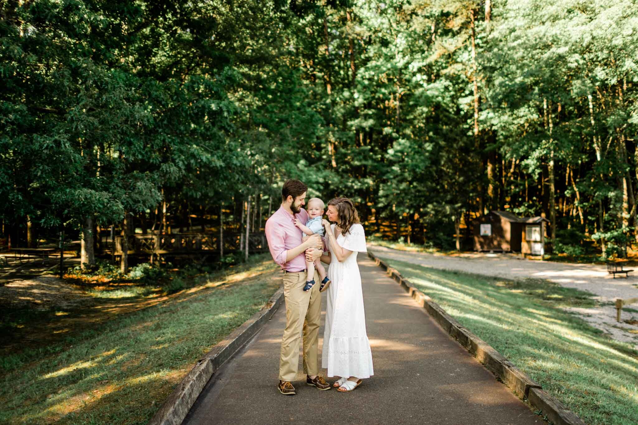 Raleigh Family Photographer | By G. Lin Photography | Umstead Park | Wide shot of family portrait in natural forest setting