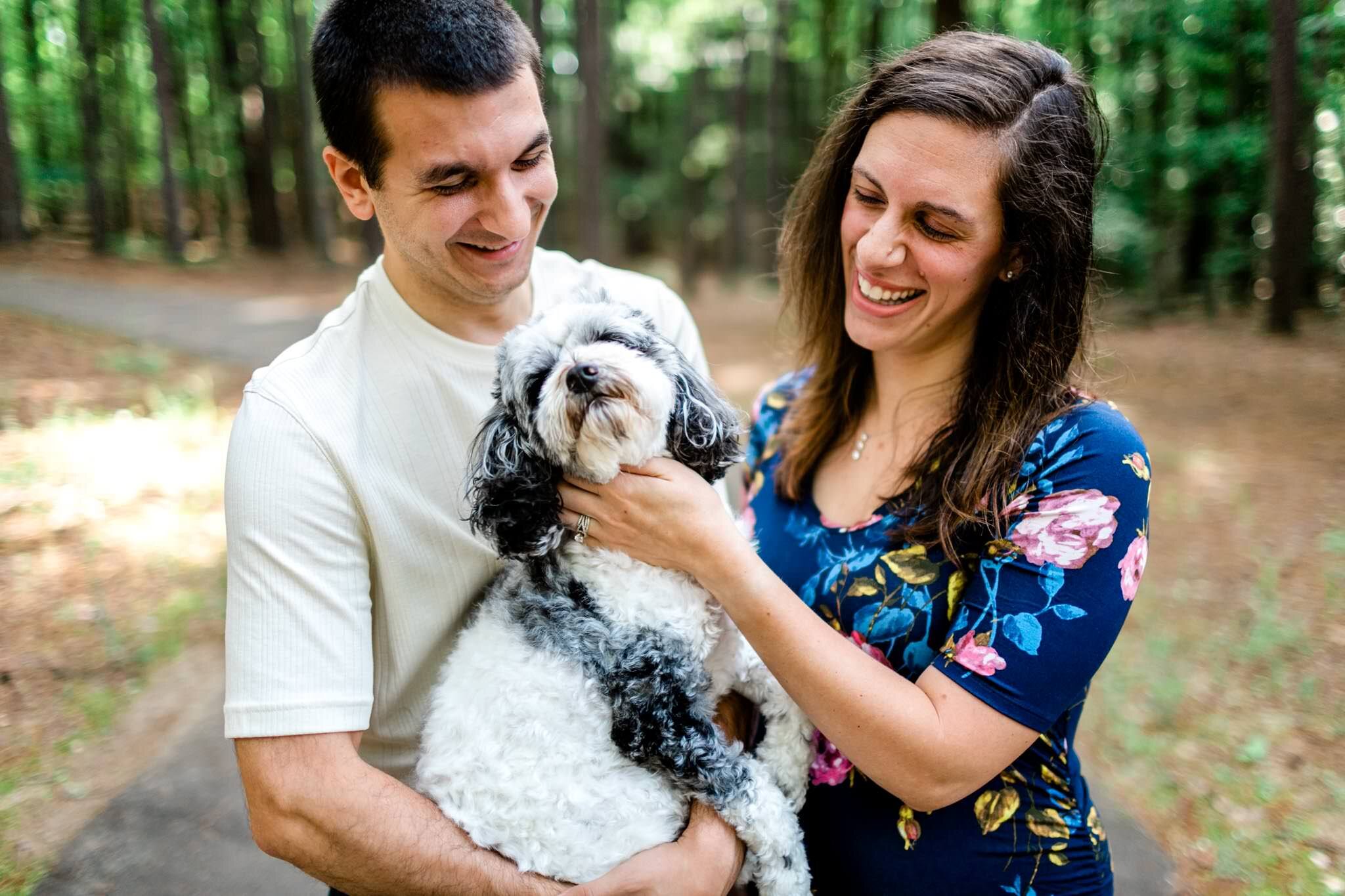 Raleigh Maternity Photographer | By G. Lin Photography | Umstead Park | Couple laughing and smiling with dog