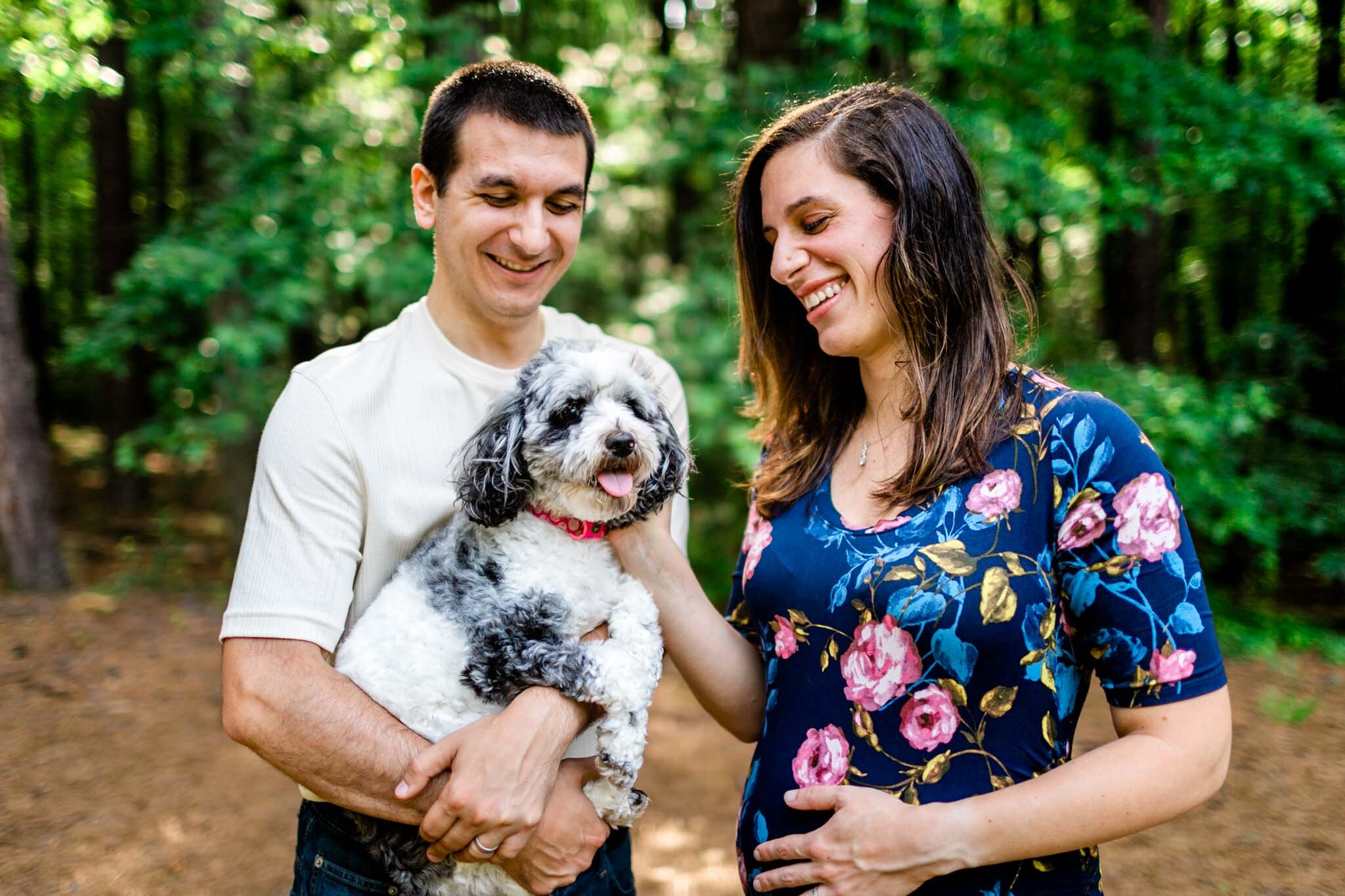 Raleigh Maternity Photographer | By G. Lin Photography | Umstead Park | Candid family photo of couple petting dog