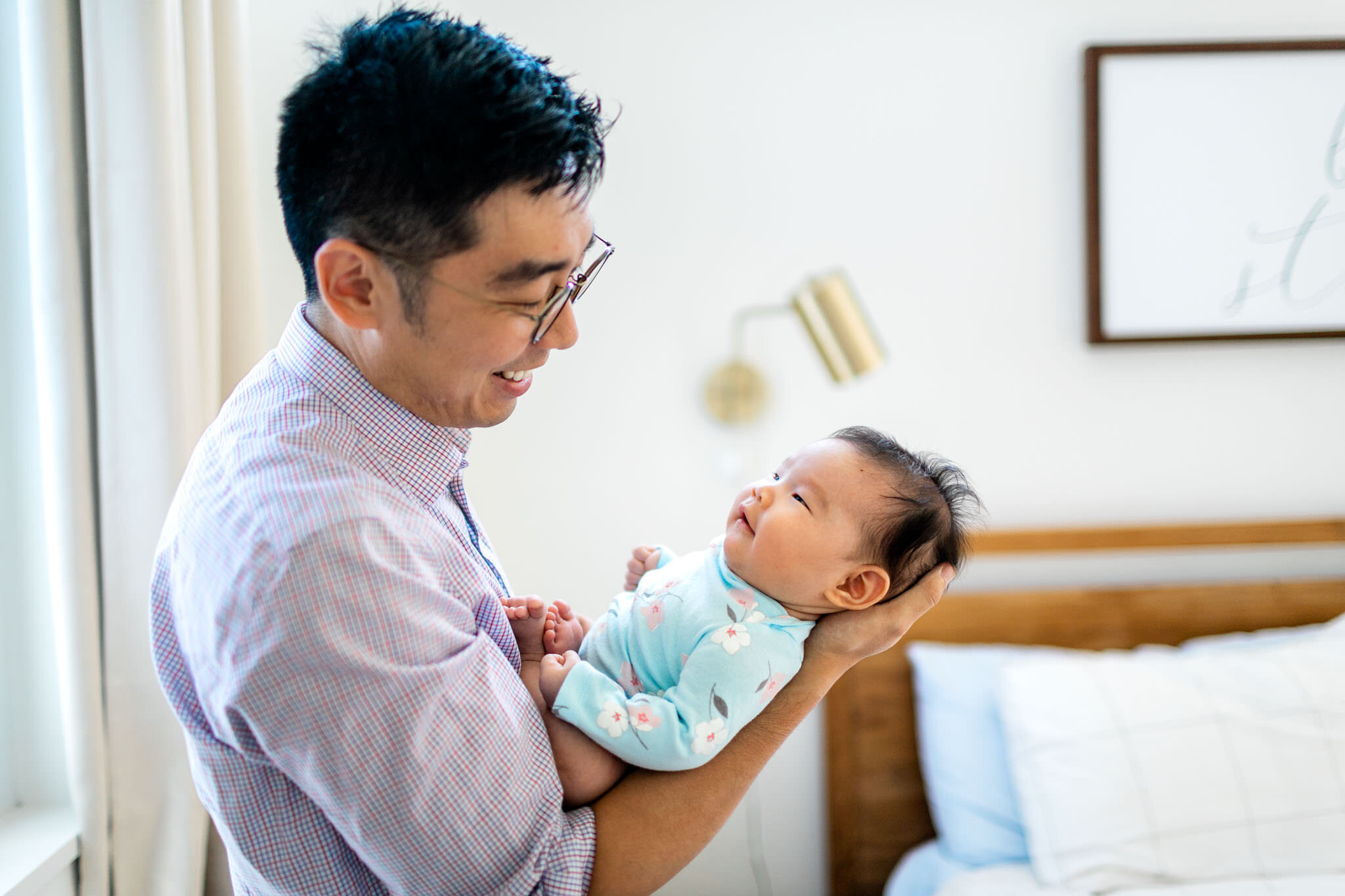 Raleigh Newborn Photographer | By G. Lin Photography | Father smiling and holding baby girl