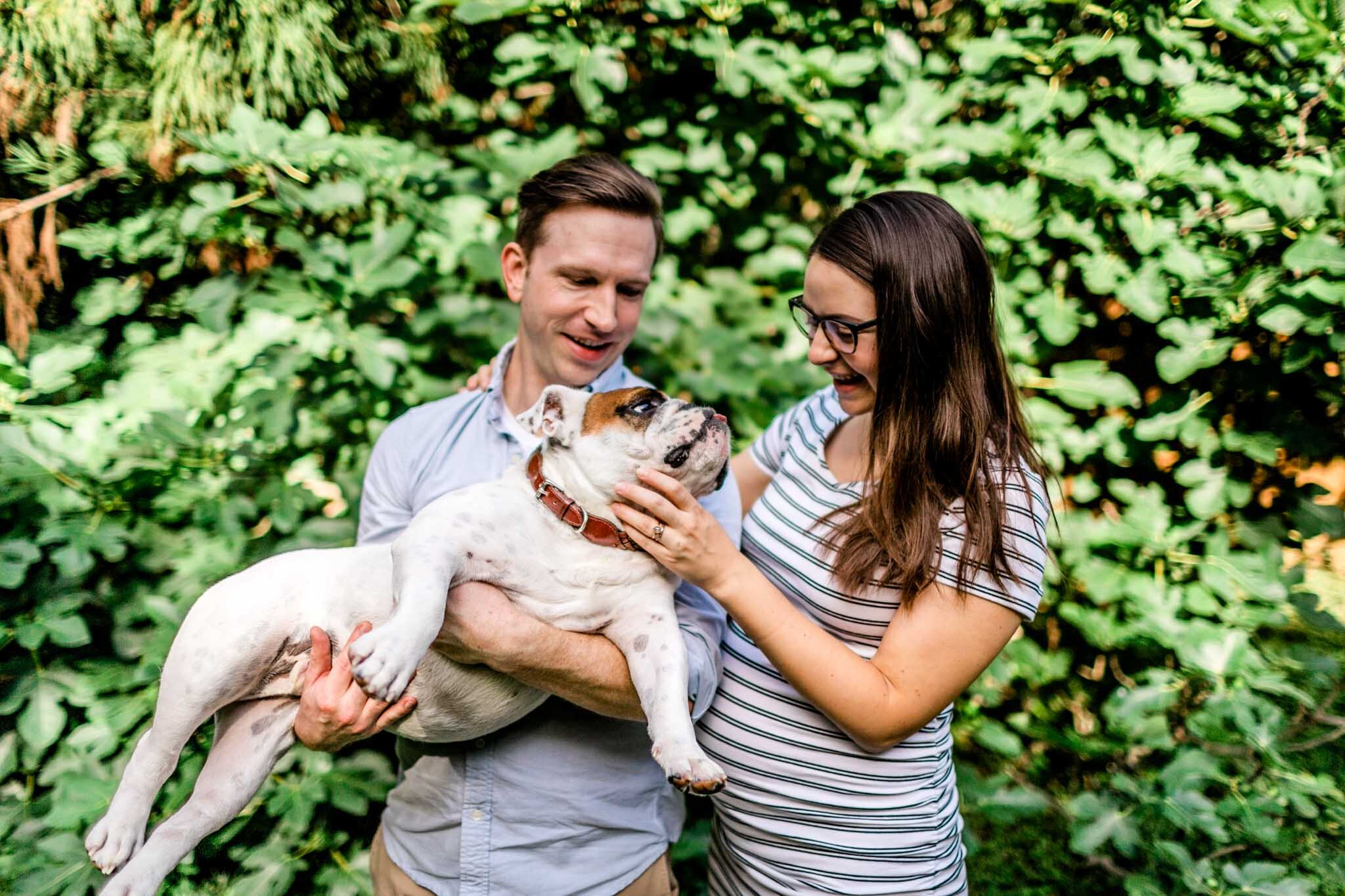 Durham Maternity Photographer | By G. Lin Photography | Husband and wife holding bulldog outside and laughing