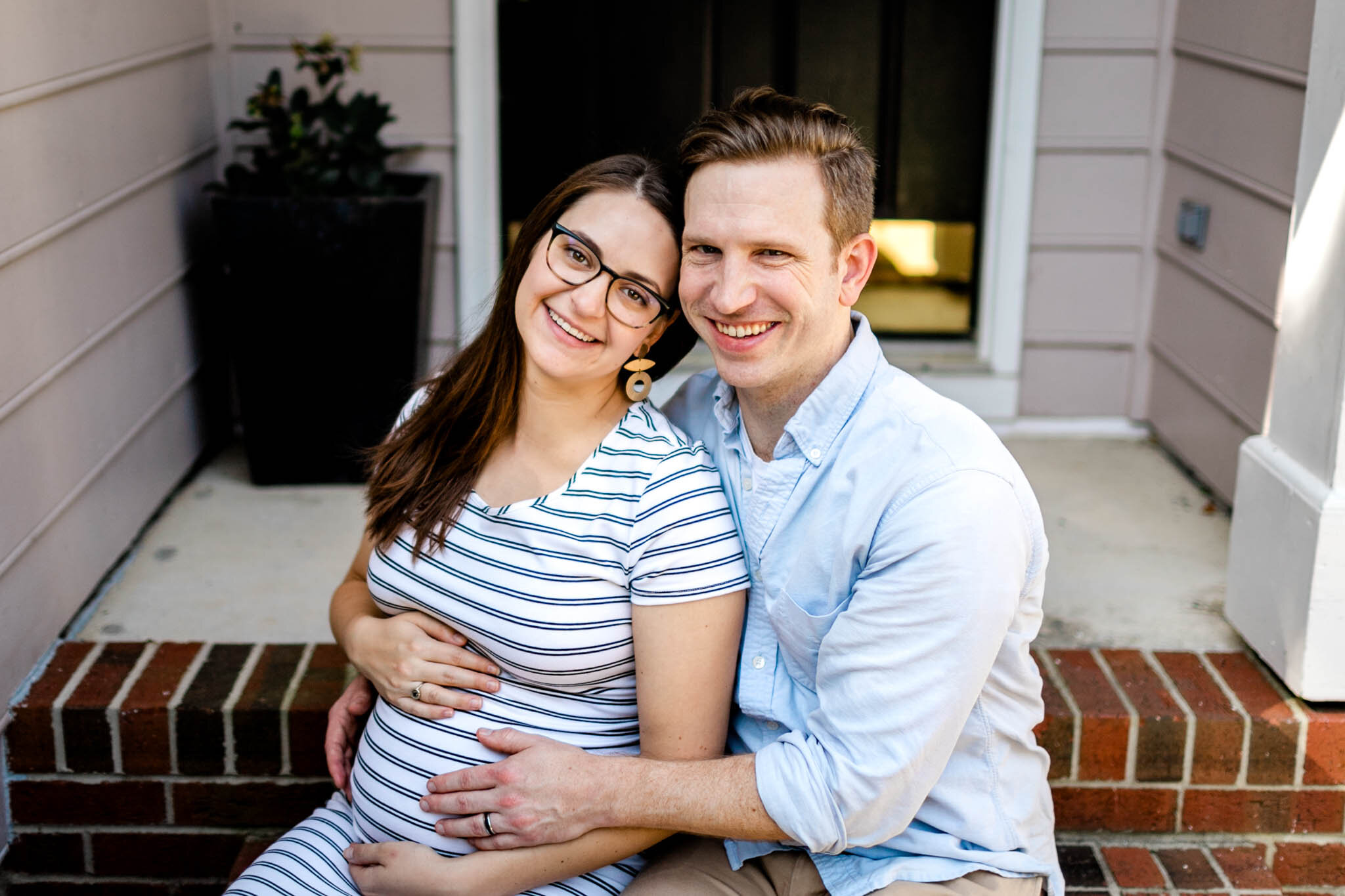 Durham Maternity Photographer | By G. Lin Photography | Couple sitting on front porch steps and smiling