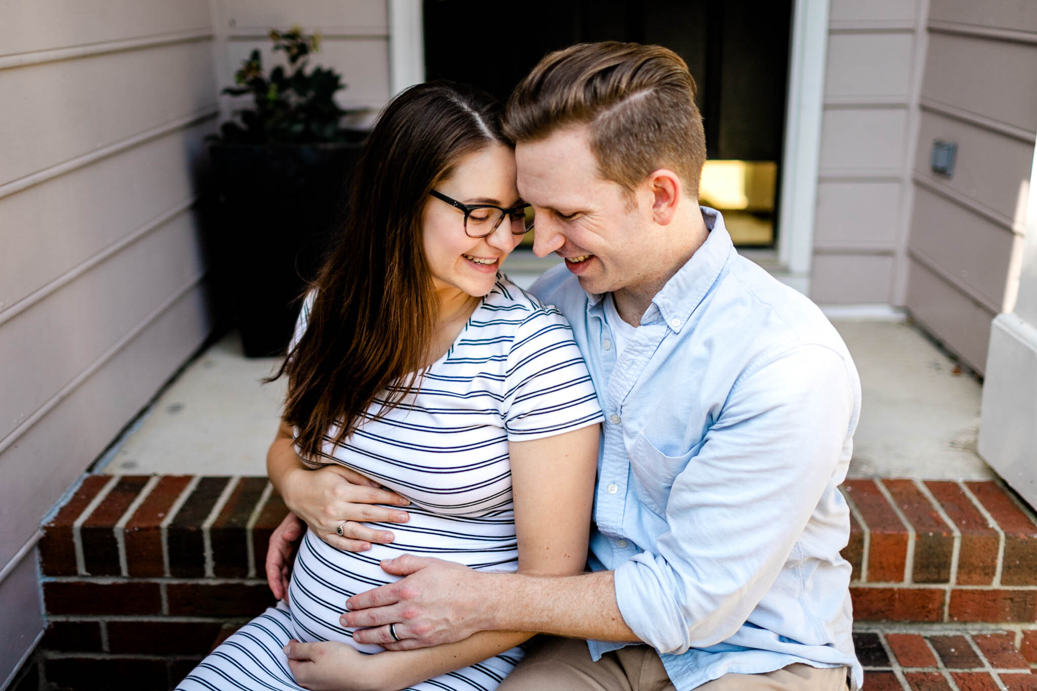 Durham Maternity Photographer | By G. Lin Photography | Couple laughing and sitting on front porch steps