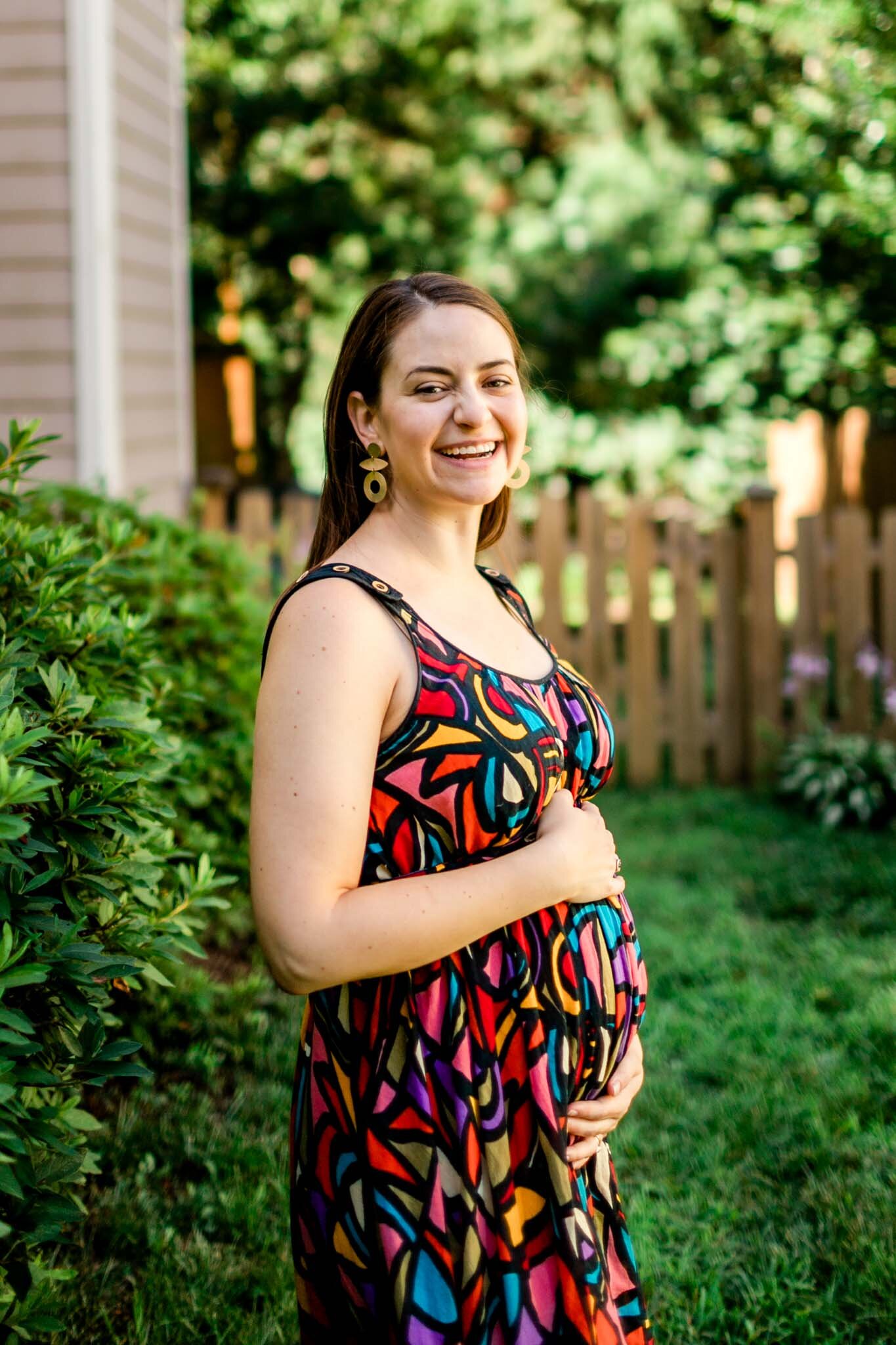 Durham Maternity Photographer | By G. Lin Photography | Candid lifestyle maternity photo of woman holding baby bump