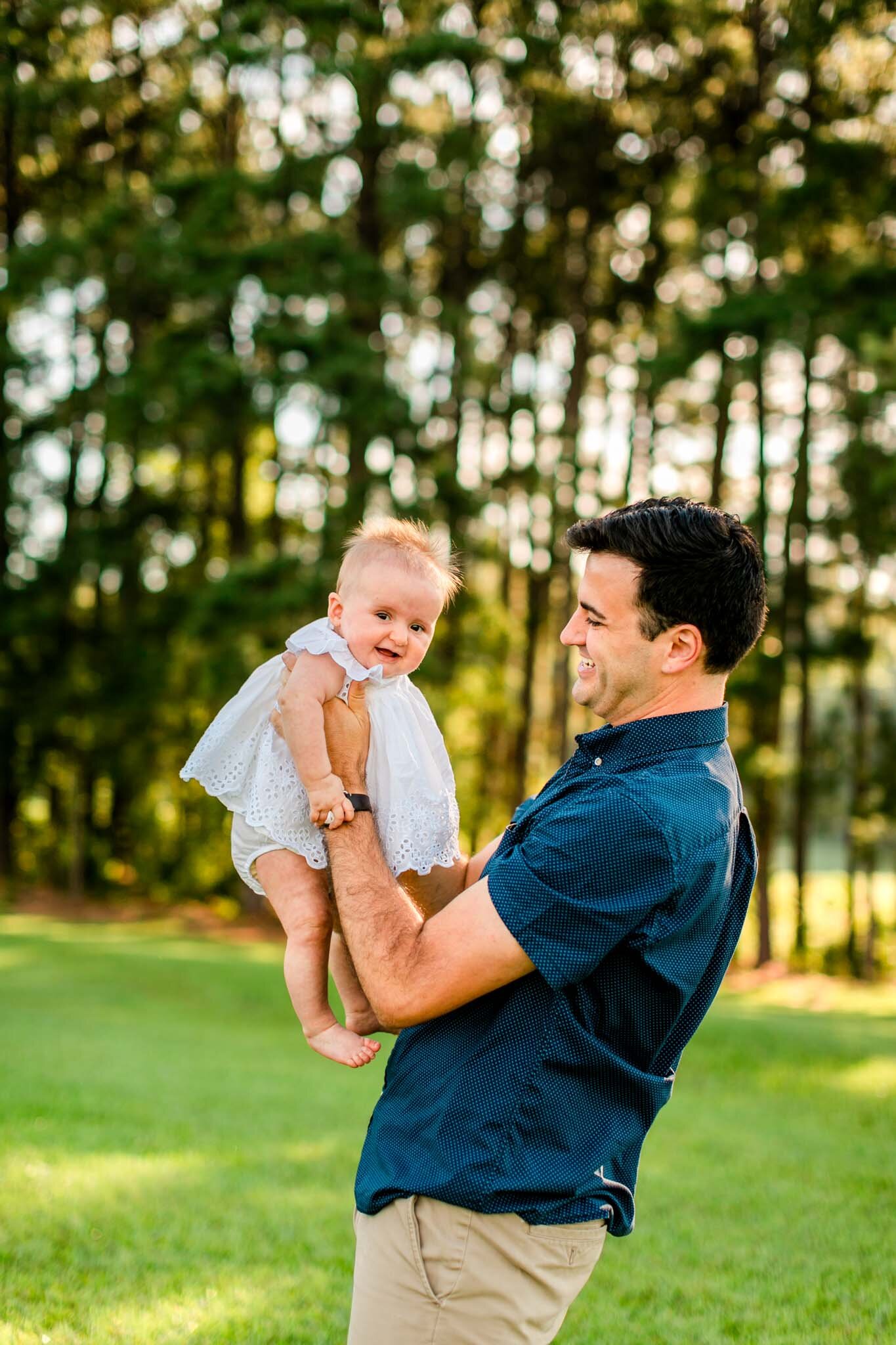 Raleigh Family Photographer | By G. Lin Photography | Dix Park | Candid photo of dad holding baby girl