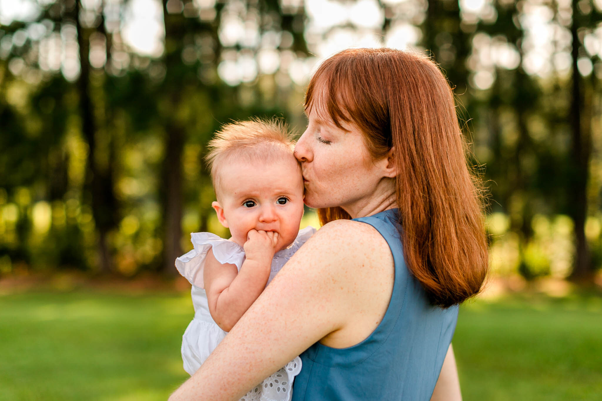 Raleigh Family Photographer | By G. Lin Photography | Dix Park | Candid and genuine photo of mom kissing baby girl