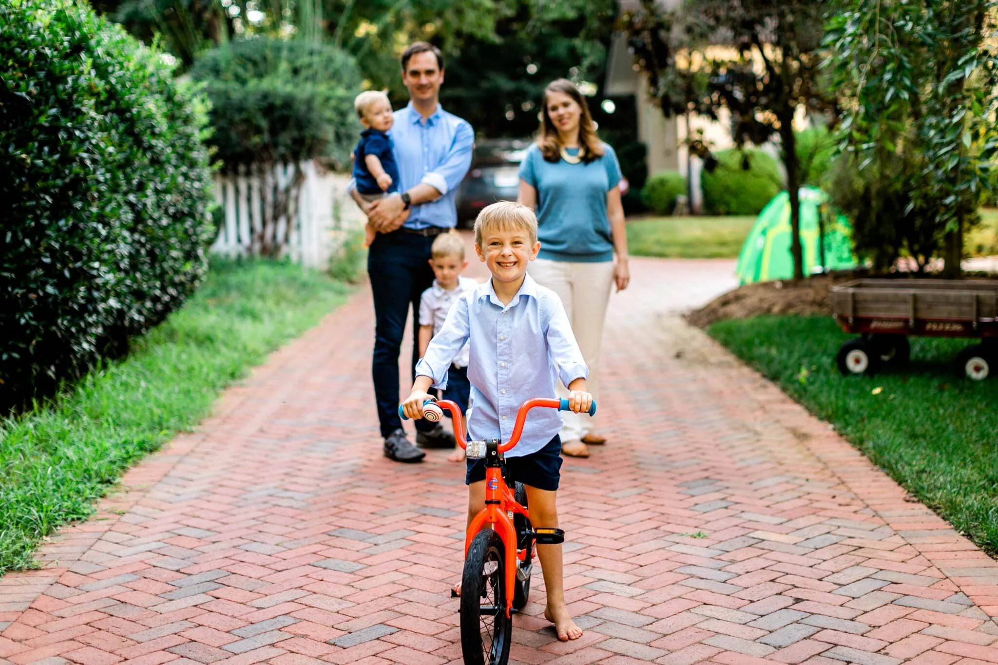 Raleigh Family Photographer | By G. Lin Photography | Young boy smiling and sitting on bike