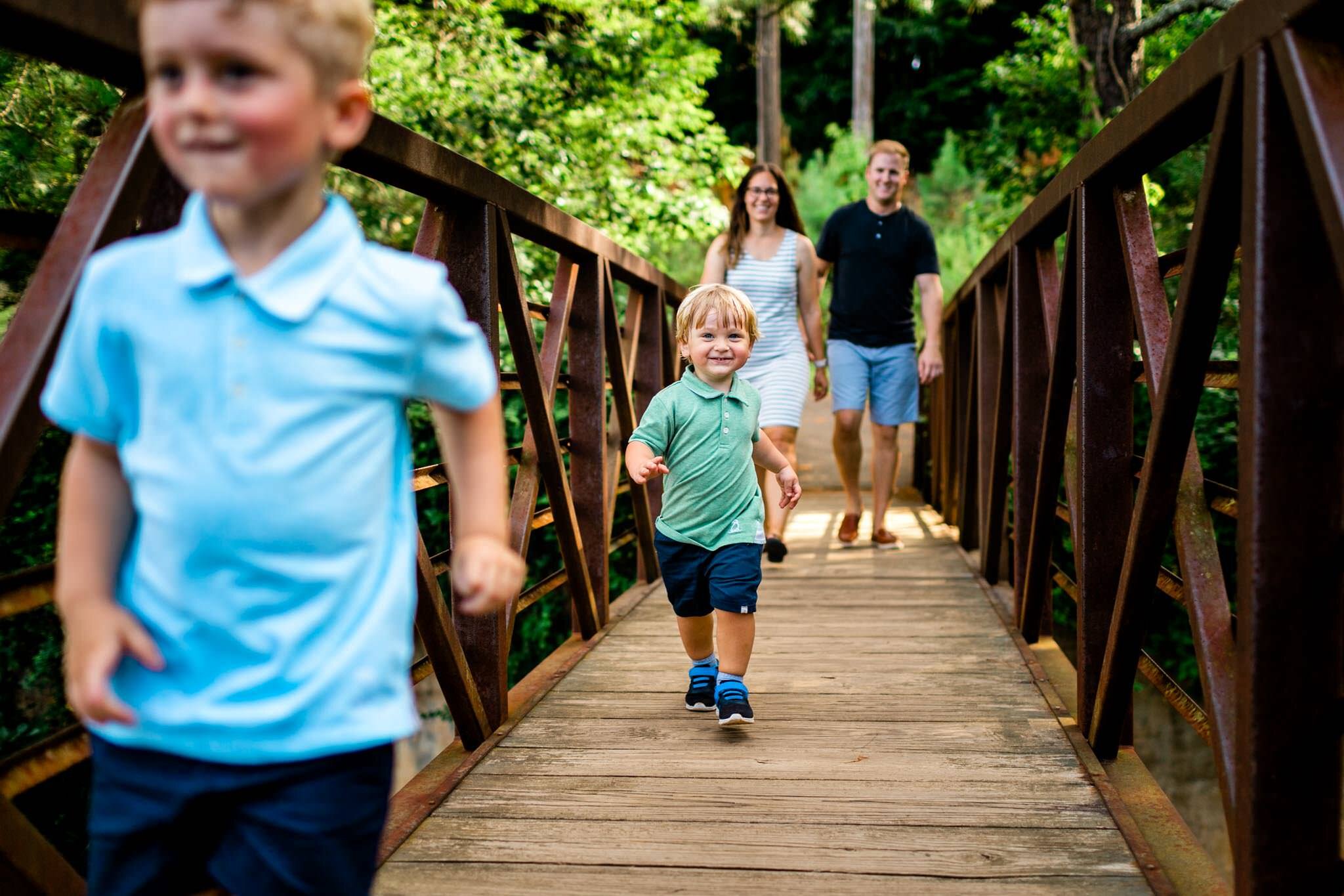 Raleigh Family Photographer | Umstead Park | By G. Lin Photography | Boys running across bridge