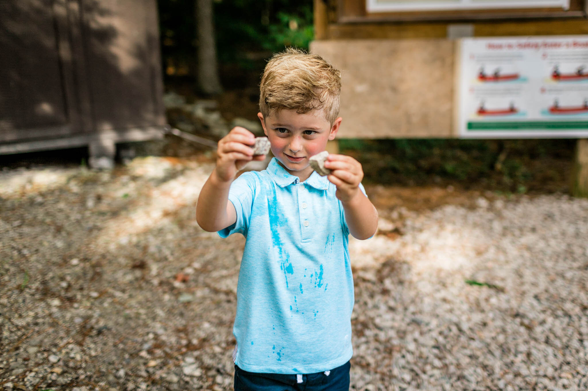Raleigh Family Photographer | Umstead Park | By G. Lin Photography | Young boy holding up rocks