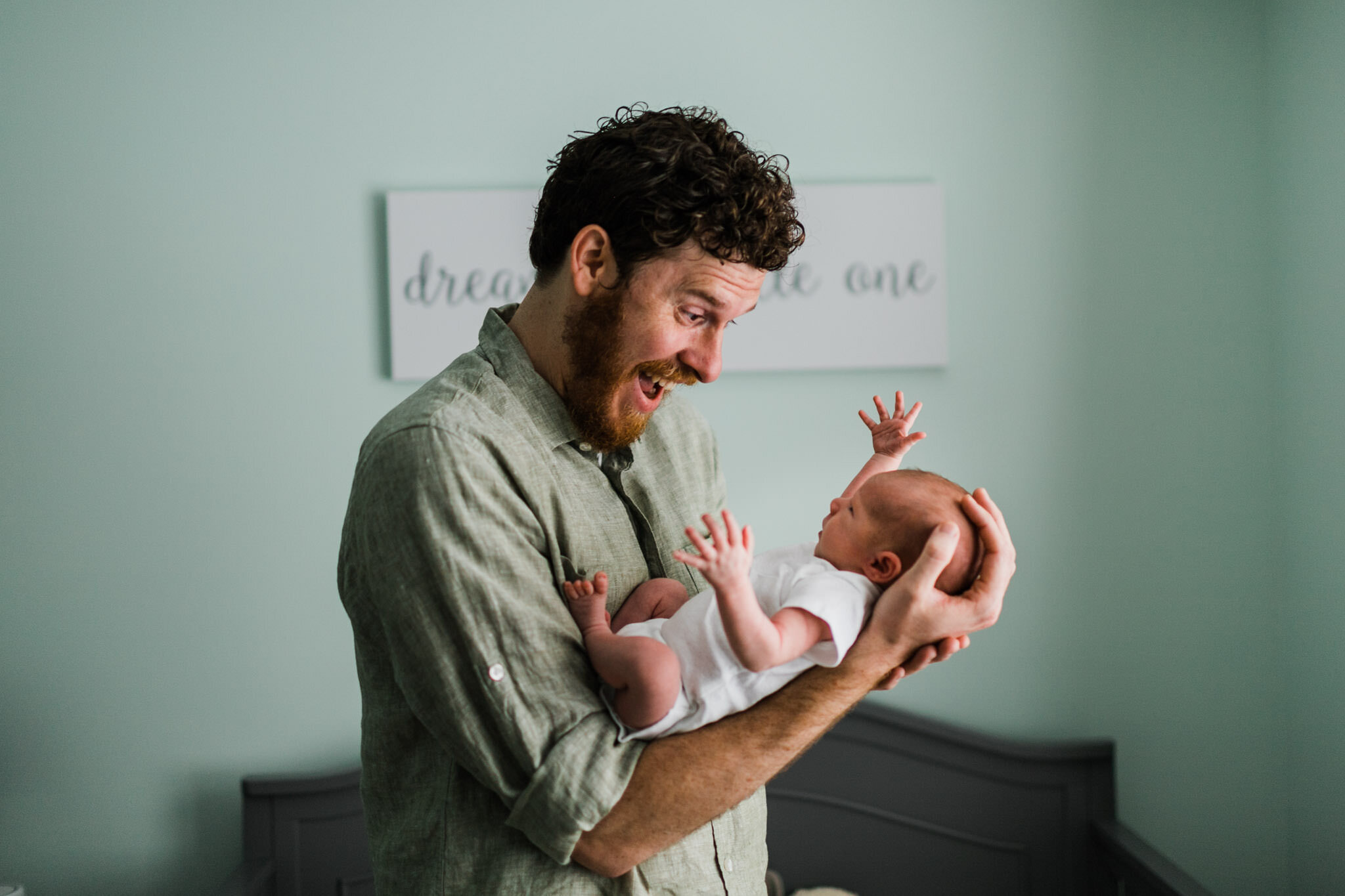 Raleigh Newborn Photographer | By G. Lin Photography | Father laughing while holding baby boy