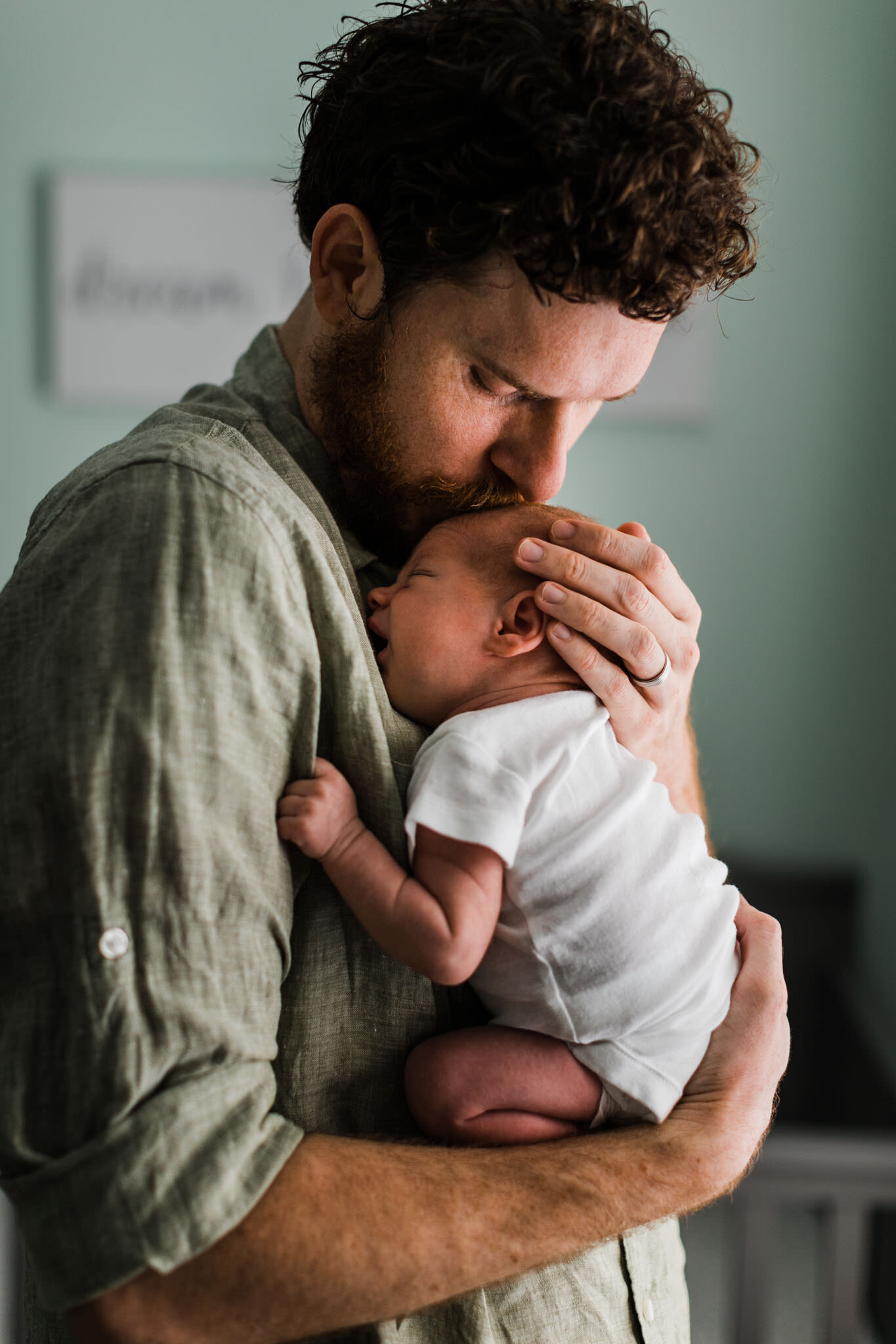 Raleigh Newborn Photographer | By G. Lin Photography | Dad kissing baby son on head