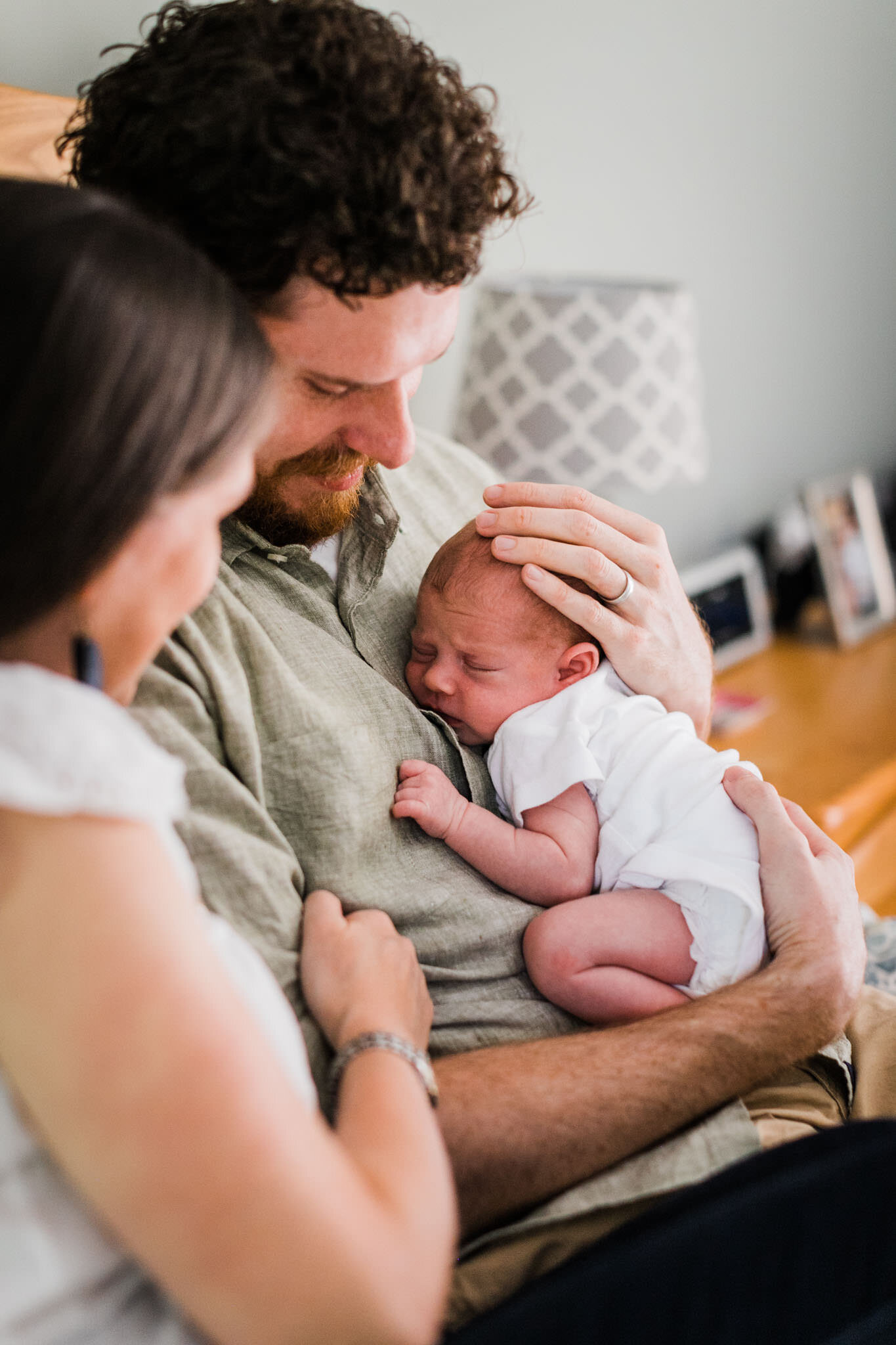 Raleigh Newborn Photographer | By G. Lin Photography | Father holding baby against chest
