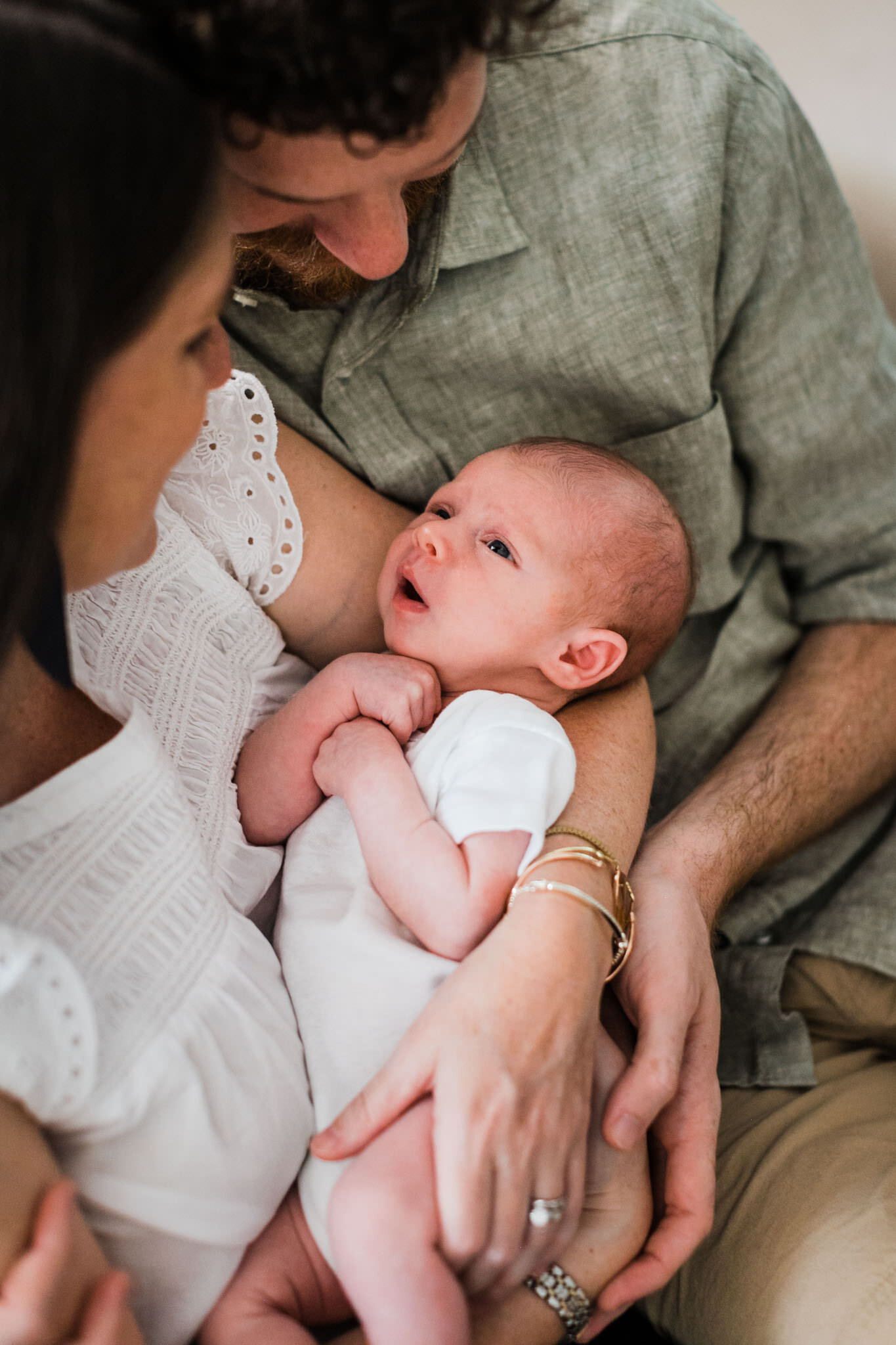 Raleigh Newborn Photographer | By G. Lin Photography | Baby looking up at parents inside home