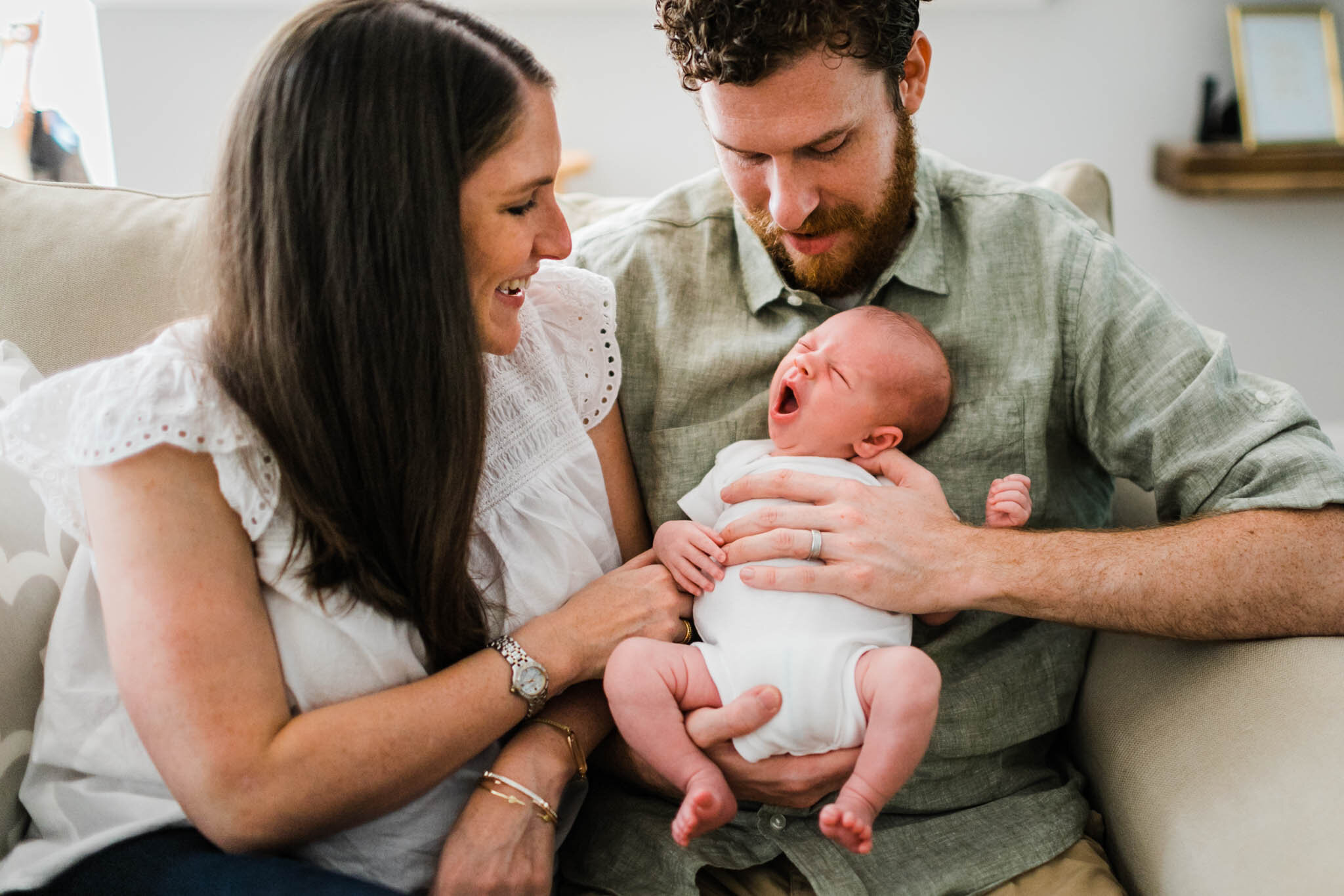 Raleigh Newborn Photographer | By G. Lin Photography | Baby yawning inside home while parents hold him