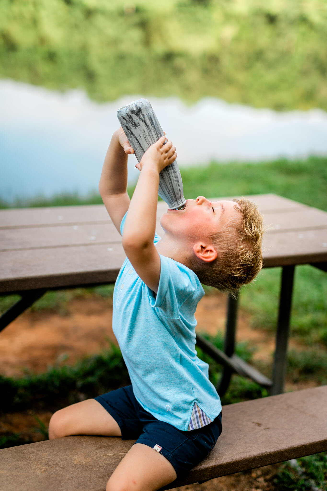 Raleigh Family Photographer | Umstead Park | By G. Lin Photography | Young boy drinking from water bottle