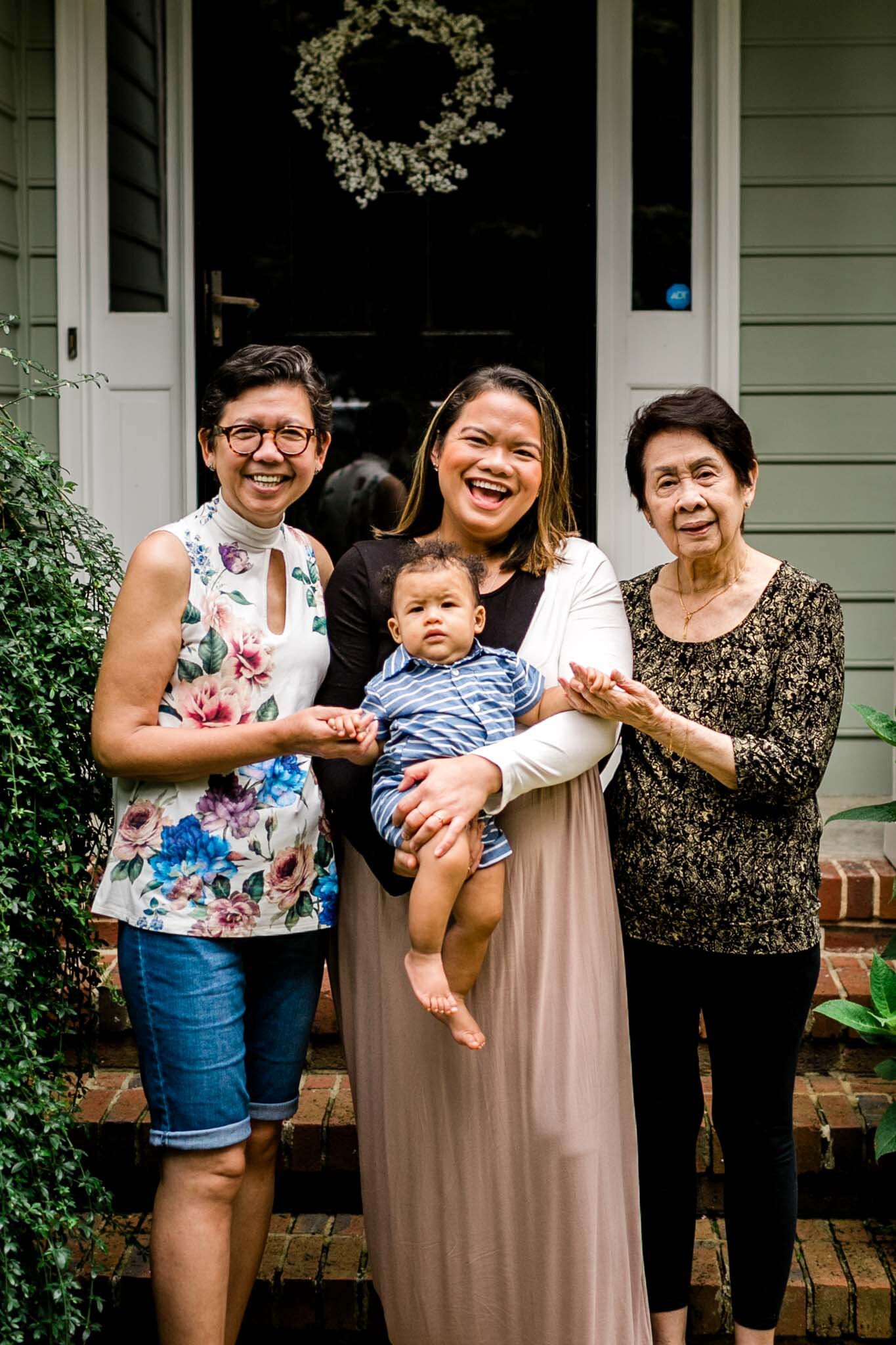 Raleigh Family Photographer | By G. Lin Photography | Candid portrait of family standing outside of home