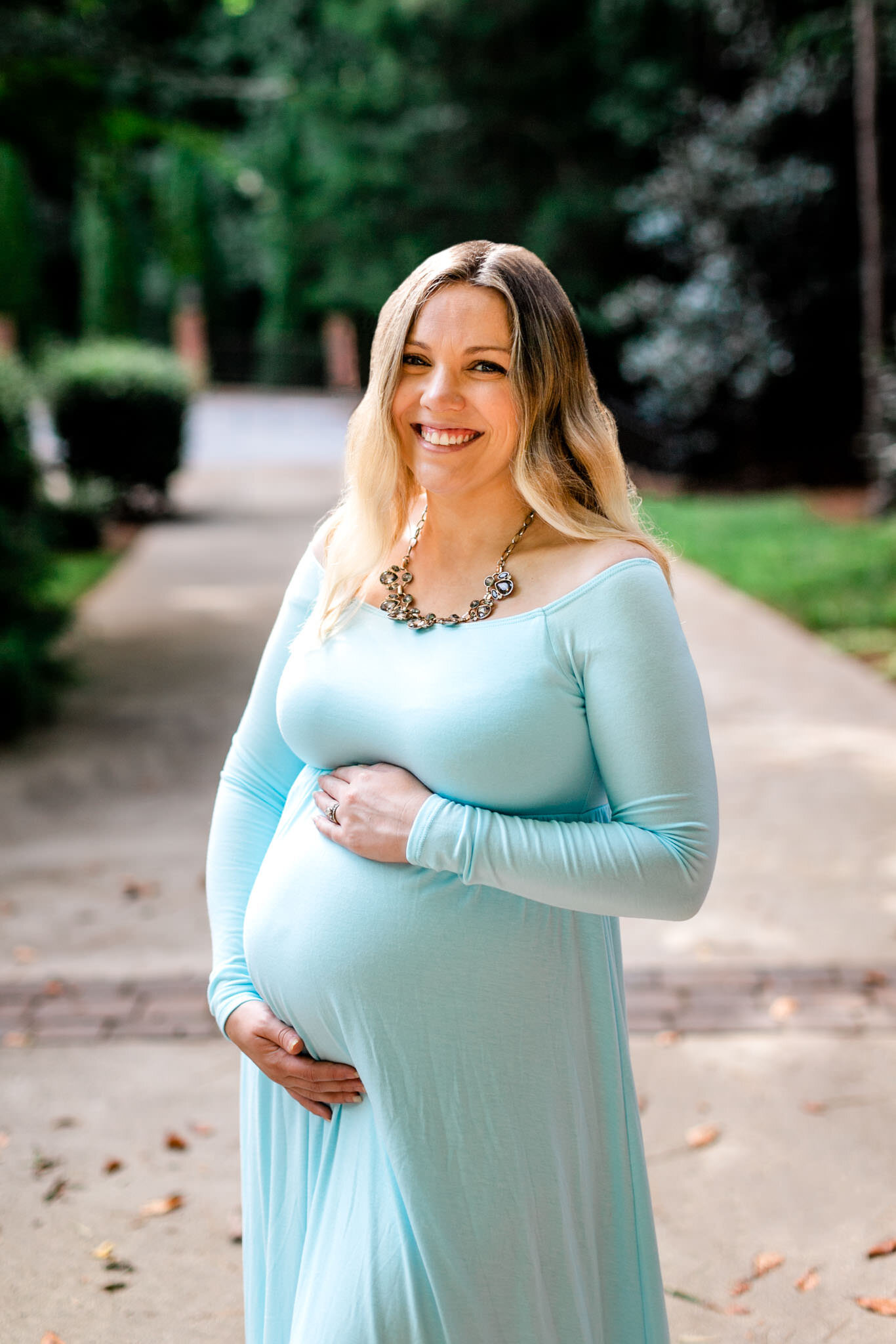 Raleigh Maternity Photographer | By G. Lin Photography | Organic candid maternity photo of woman standing outside