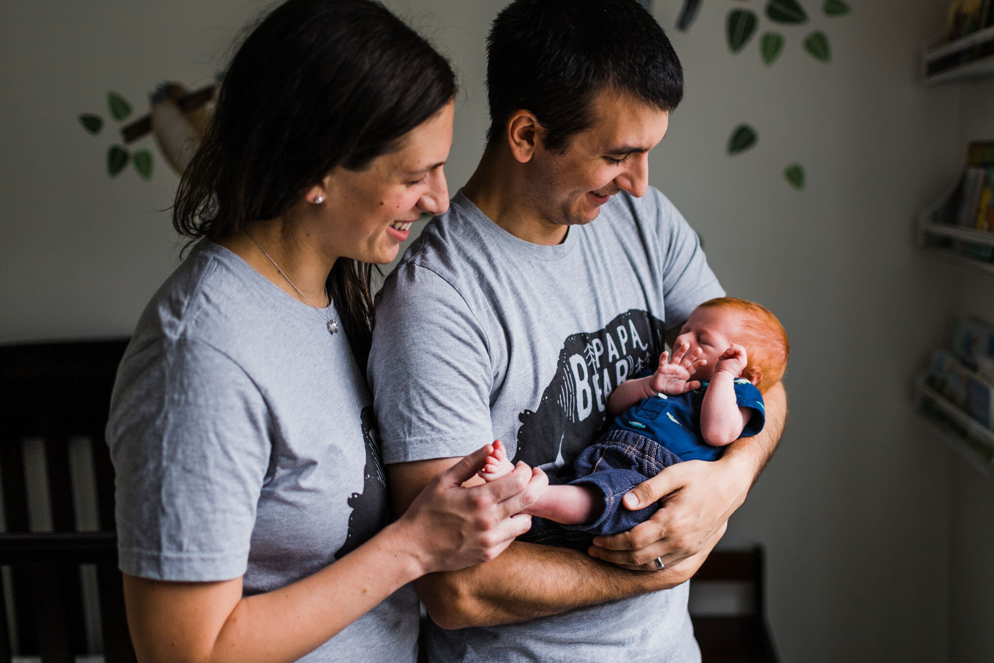 Raleigh Newborn Photographer | By G. Lin Photography | Parents holding and looking at baby