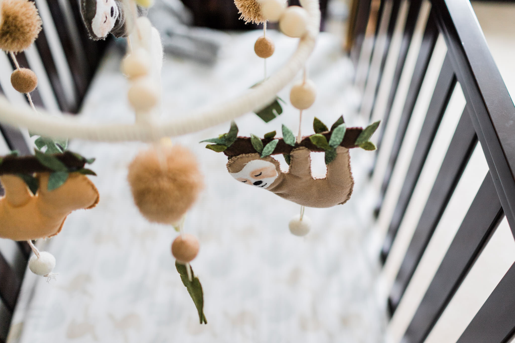 Raleigh Newborn Photographer | By G. Lin Photography | Sloth mobile in nursery crib