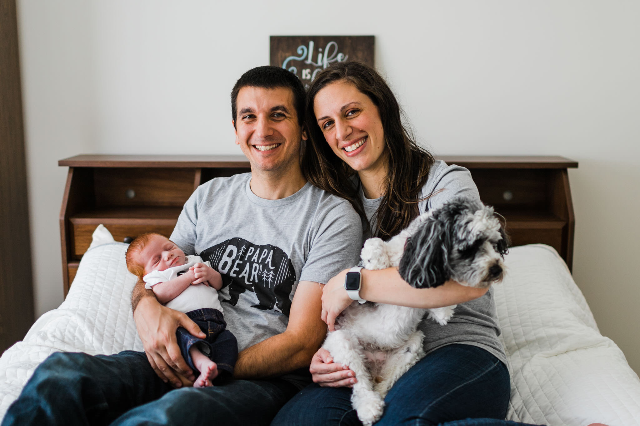 Raleigh Newborn Photographer | By G. Lin Photography | Parents with dog and baby sitting on bed