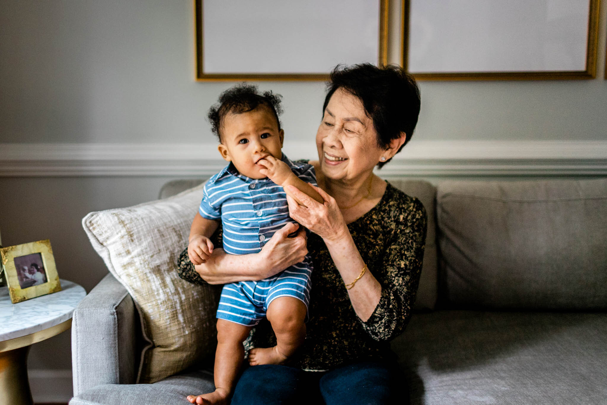 Raleigh Family Photographer | By G. Lin Photography | Woman holding baby boy on couch