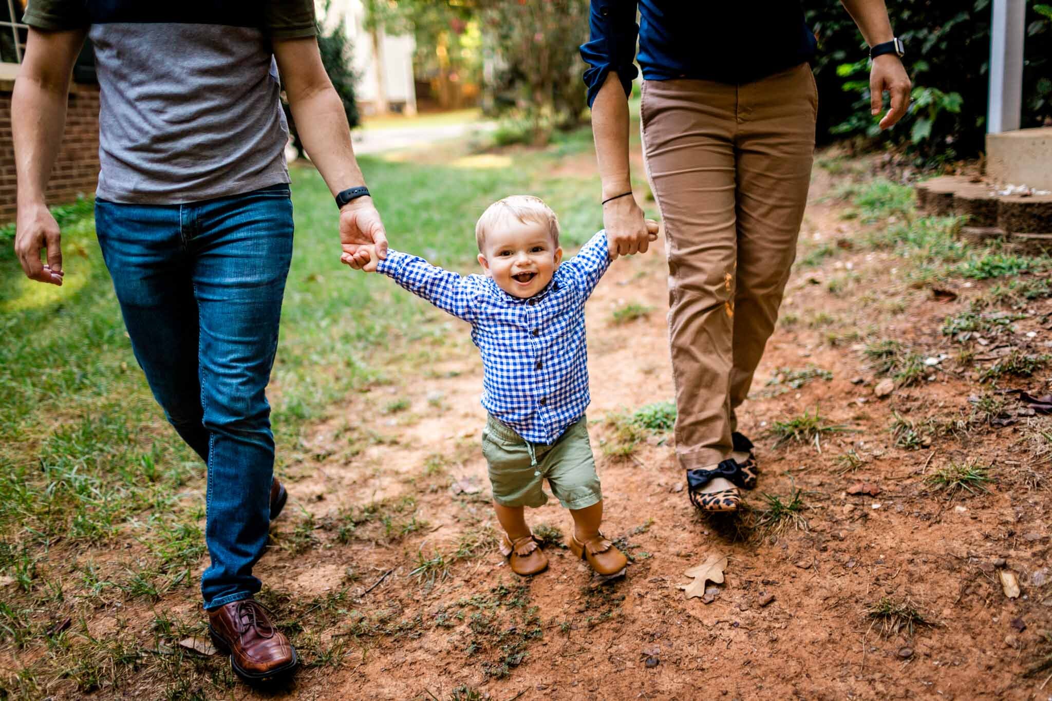 Raleigh Family Photographer | By G. Lin Photography | Baby boy holding parents hands while walking