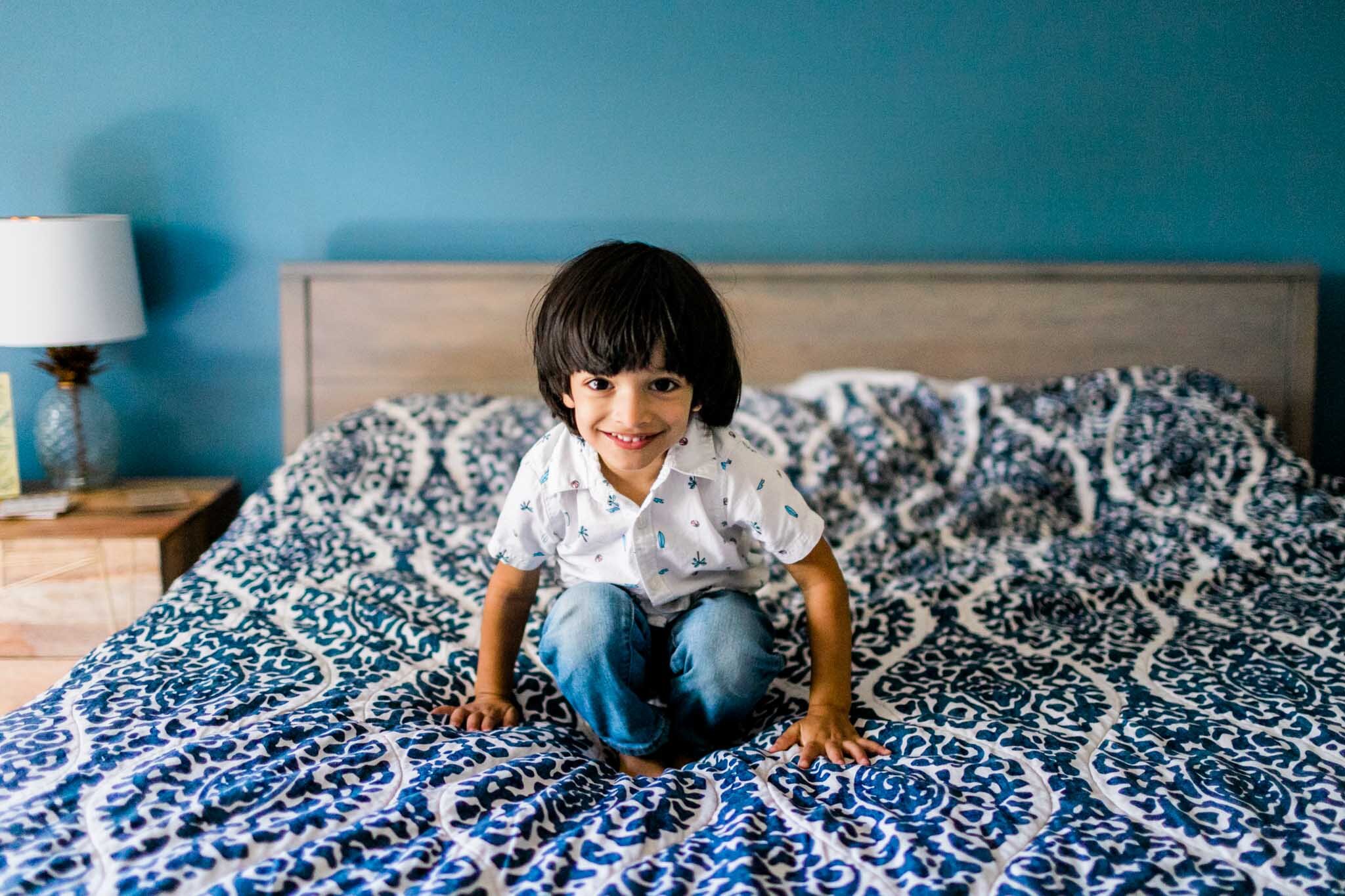 Durham Family Photographer | By G. Lin Photography | Young boy sitting on bed