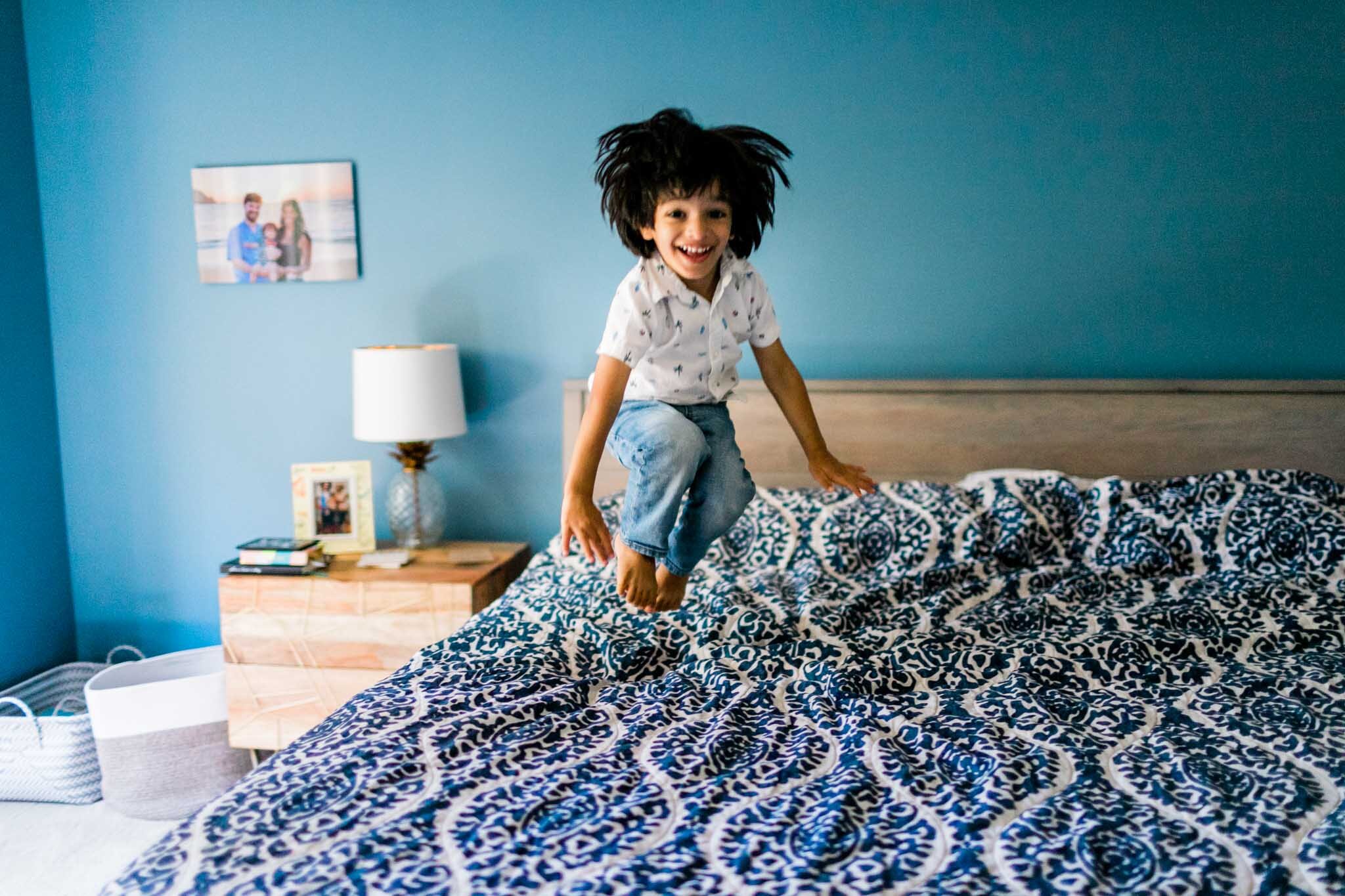 Durham Family Photographer | By G. Lin Photography | Young boy jumping on bed