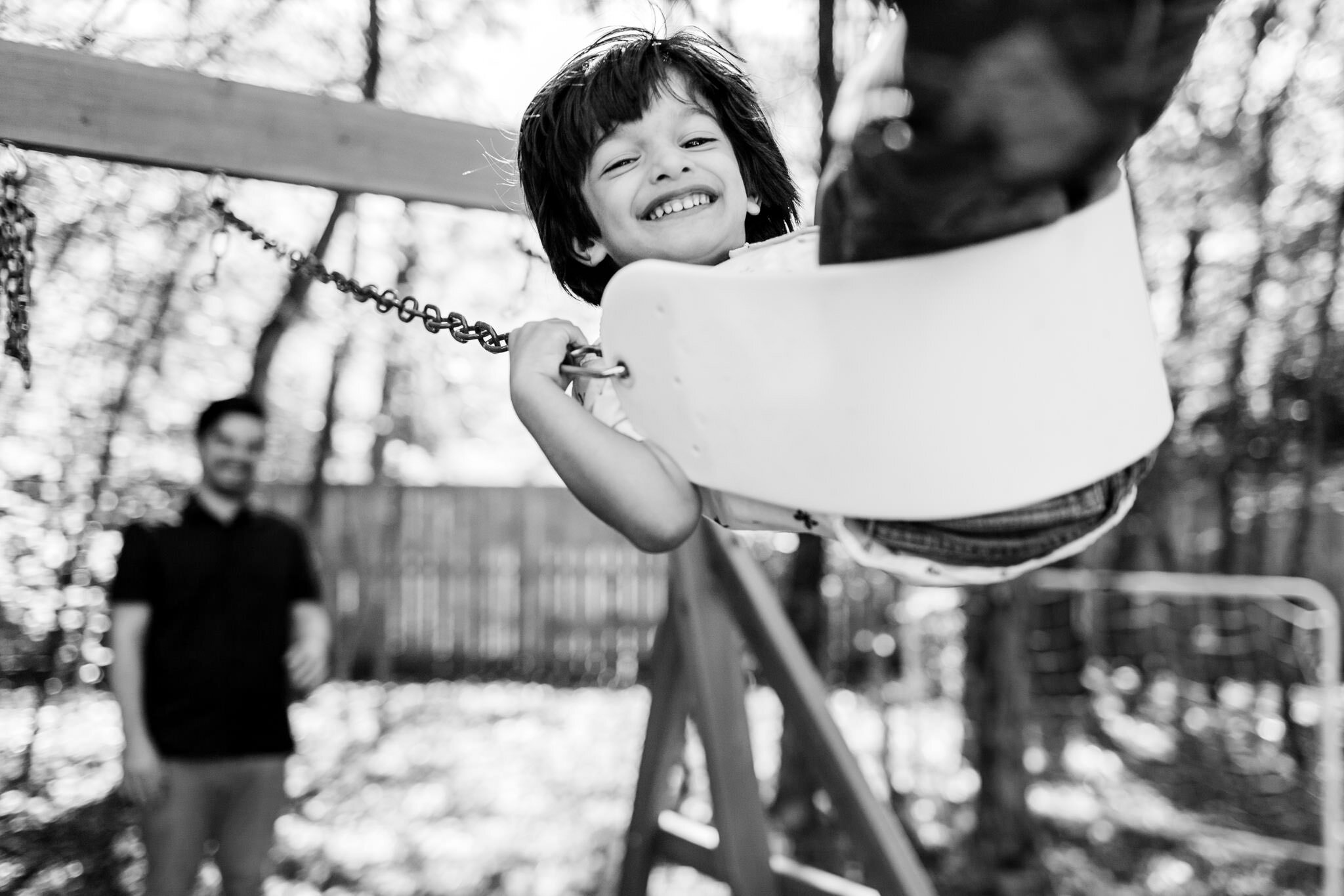 Durham Family Photographer | By G. Lin Photography | Black and white photo of boy on swing