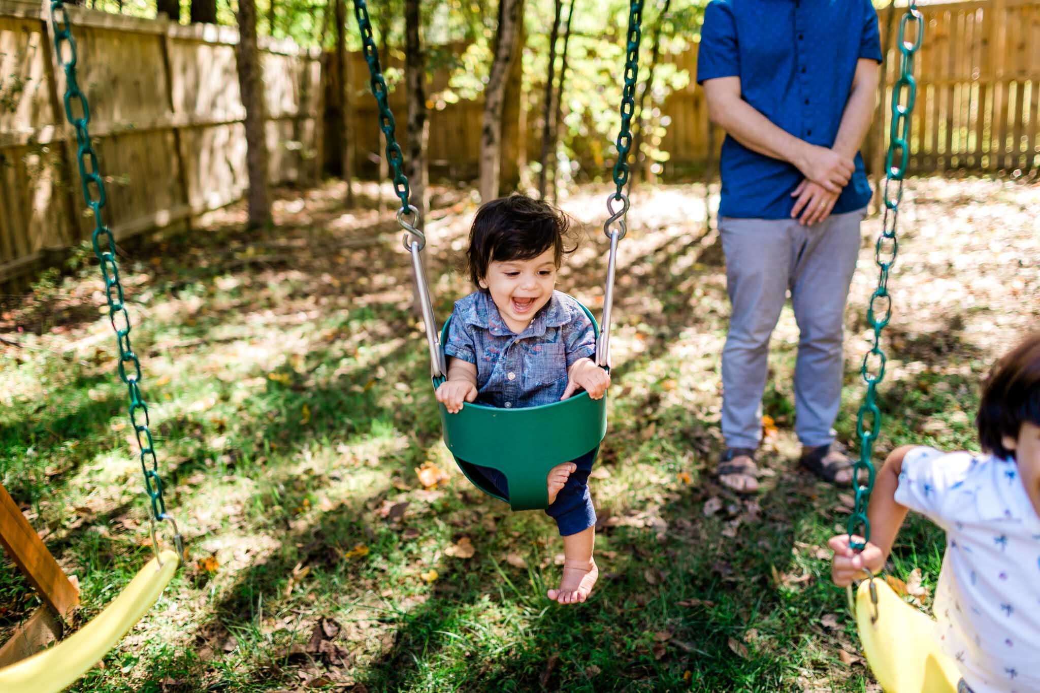 Durham Family Photographer | By G. Lin Photography | Lifestyle family photography | Candid photo of boy on swing