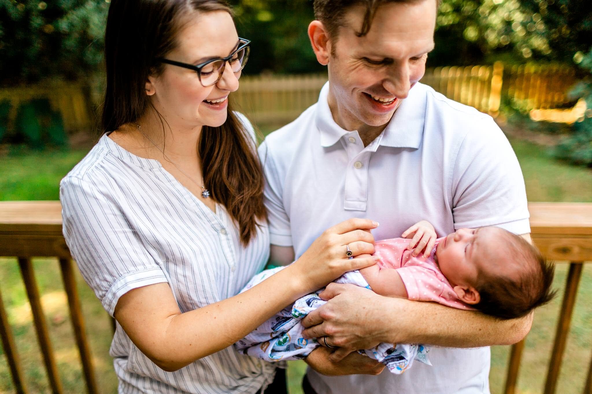 Raleigh Newborn Photographer | By G. Lin Photography | New parents laughing and smiling at baby girl