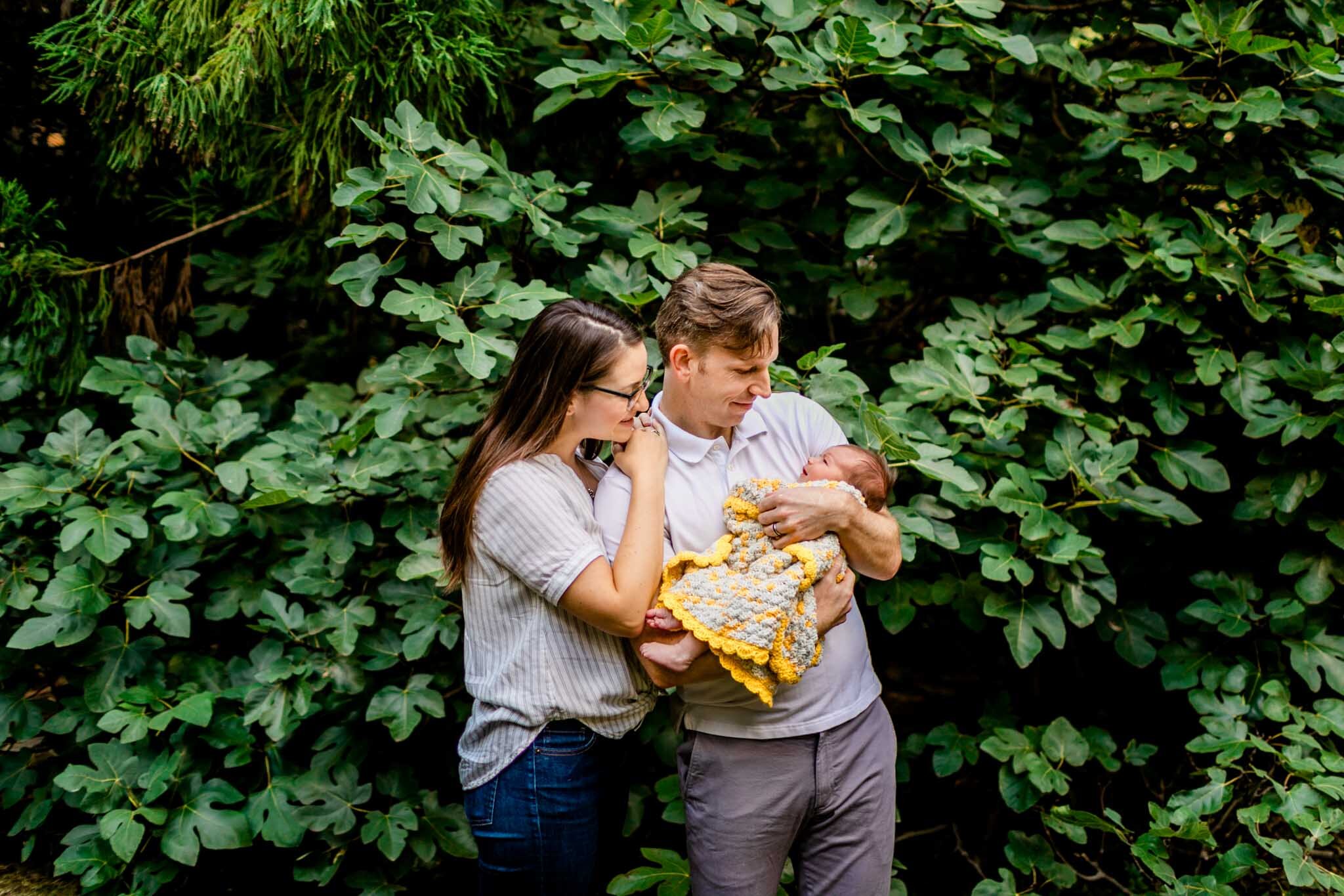 Raleigh Newborn Photographer | By G. Lin Photography | Parents holding baby while standing outside