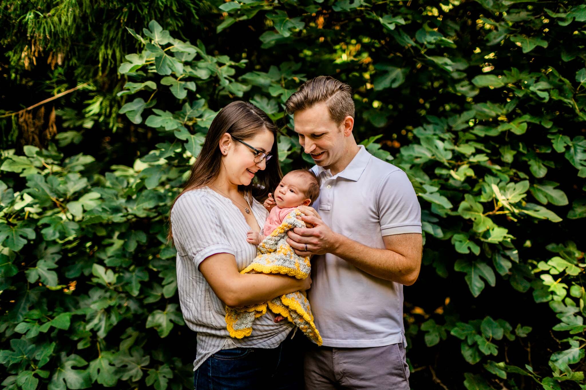 Raleigh Newborn Photographer | By G. Lin Photography | Beautiful outdoor photo of parents holding baby