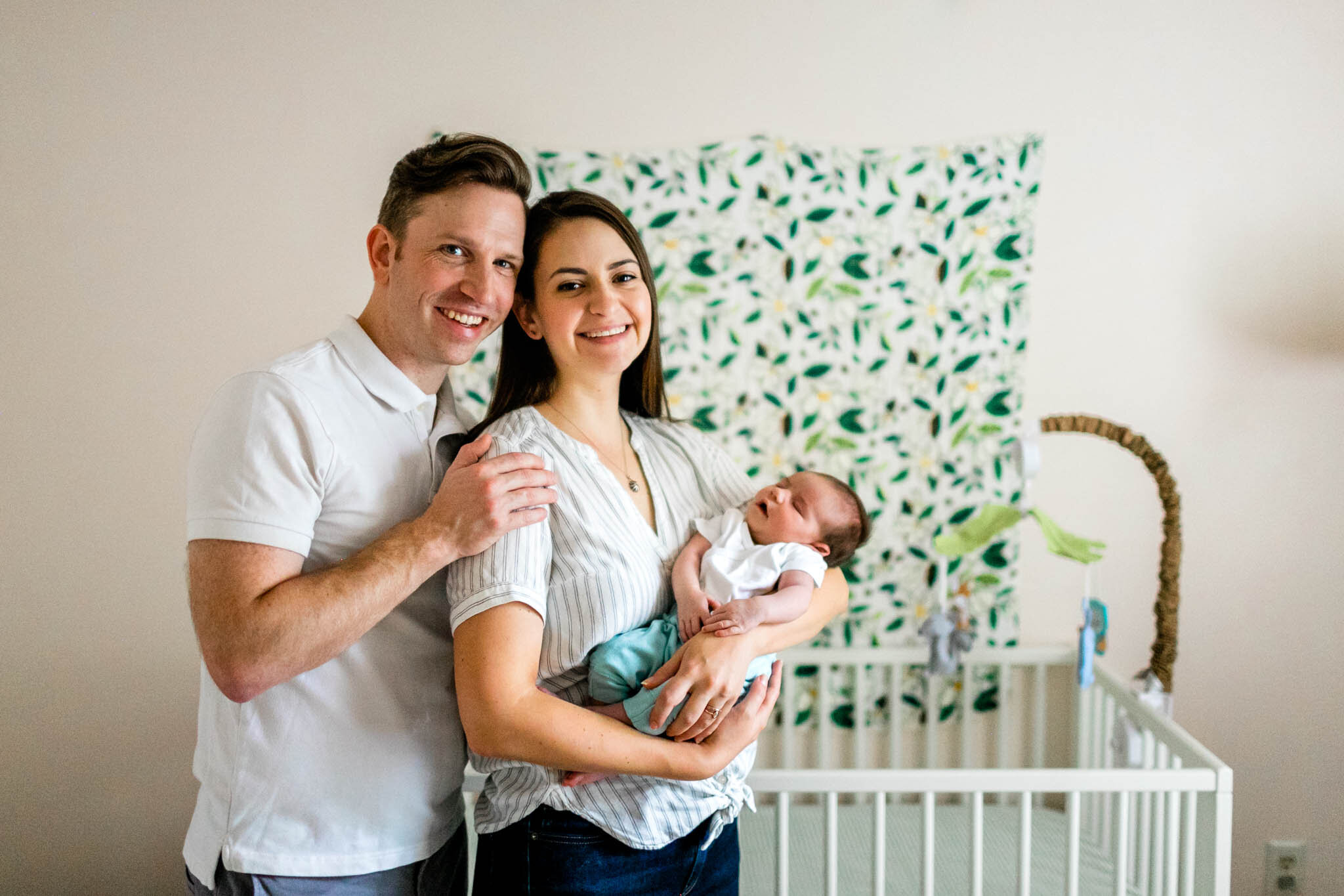 Raleigh Newborn Photographer | By G. Lin Photography | Family looking at camera and smiling while holding baby