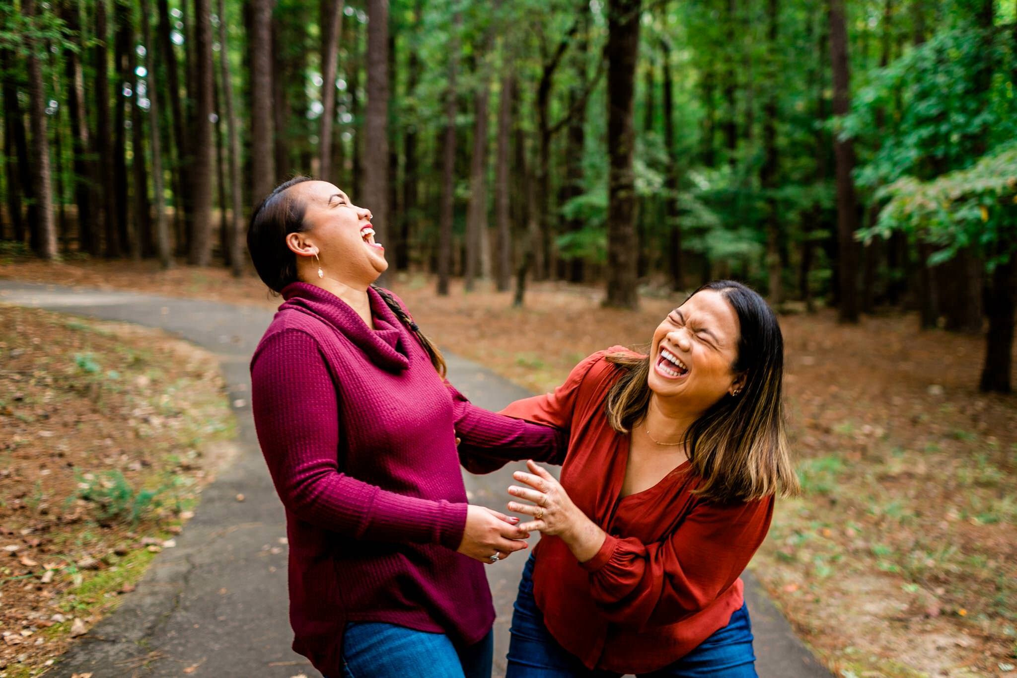 Raleigh Family Photographer | By G. Lin Photography | Umstead Park | Sisters laughing together outside