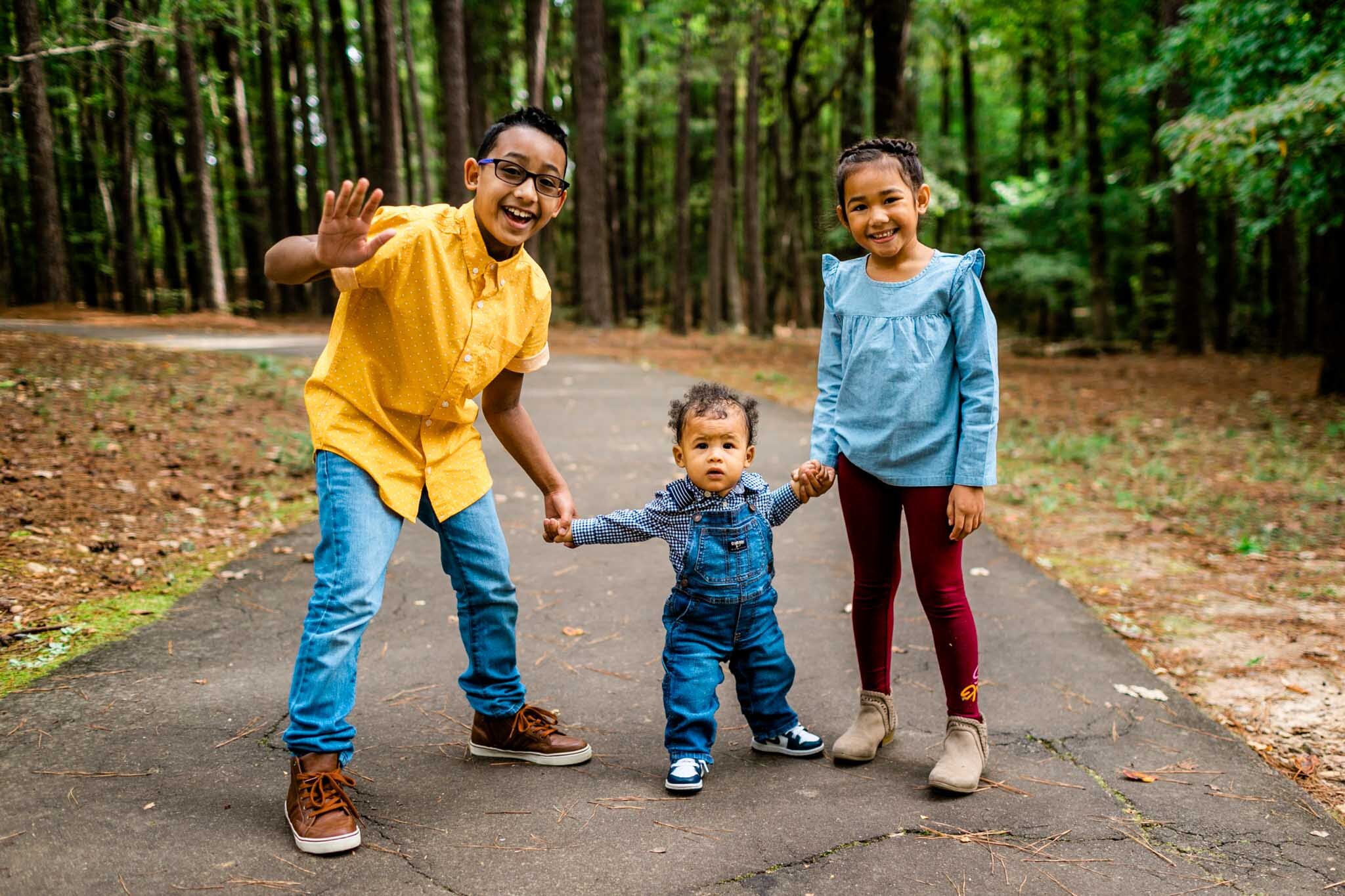 Raleigh Family Photographer | By G. Lin Photography | Umstead Park | Young boy and young girl holding hands with toddler