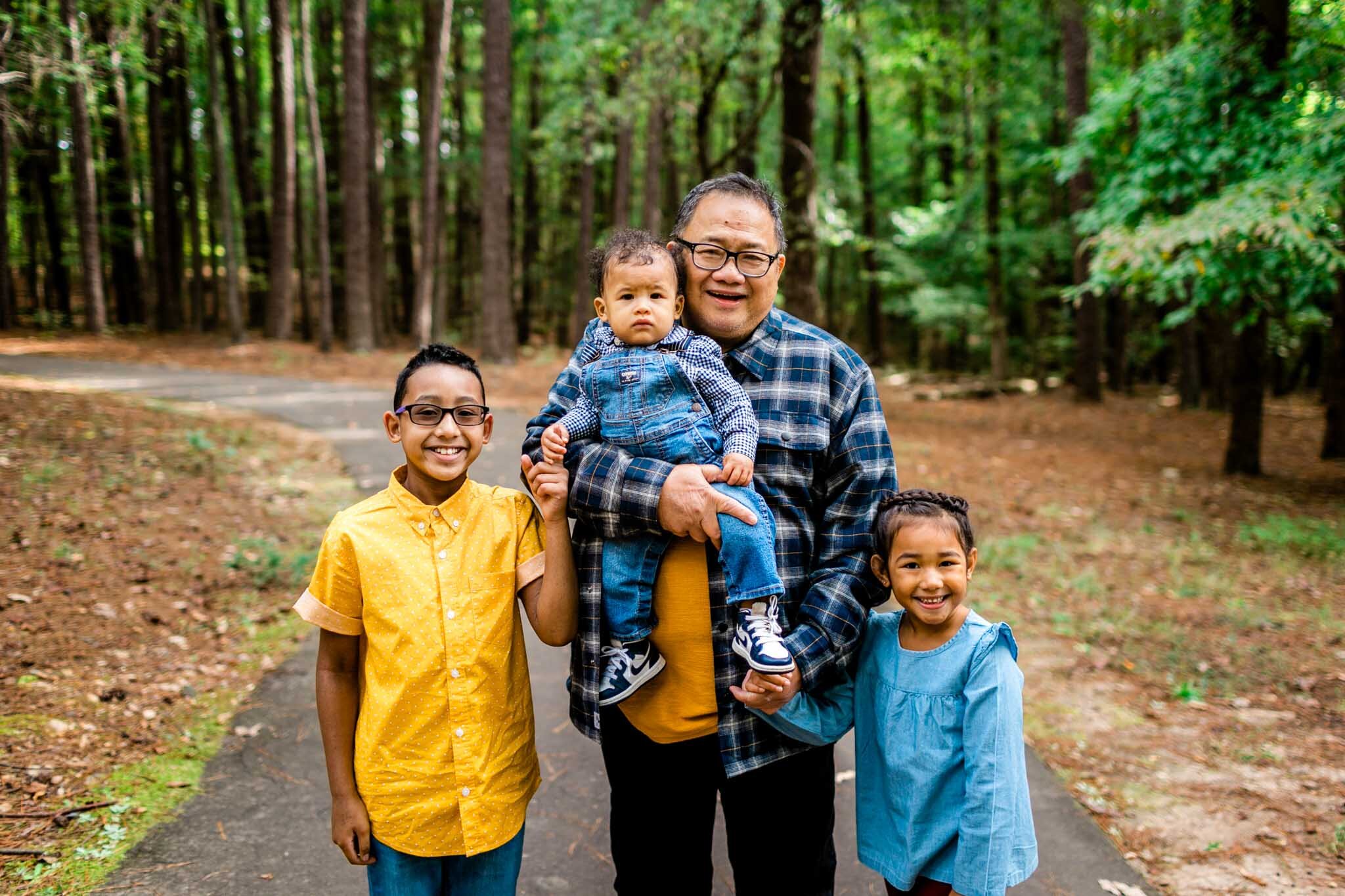 Raleigh Family Photographer | By G. Lin Photography | Umstead Park | Grandpa standing outside with three grandchildren