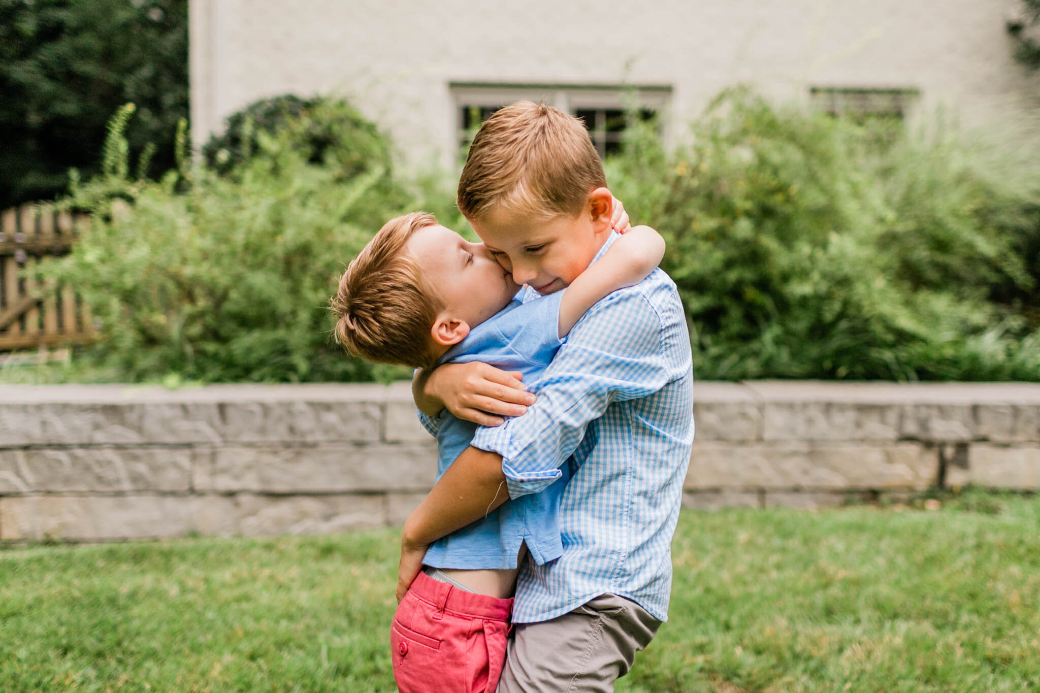 Raleigh Family Photographer | By G. Lin Photography | Younger brother giving a kiss to older brother