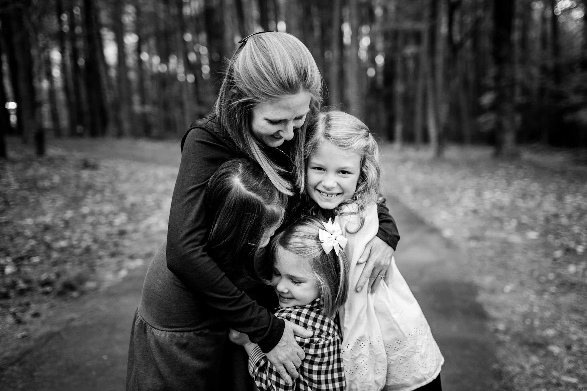 Raleigh Family Photographer | Umstead Park | By G. Lin Photography | Black and white photo of mother hugging children