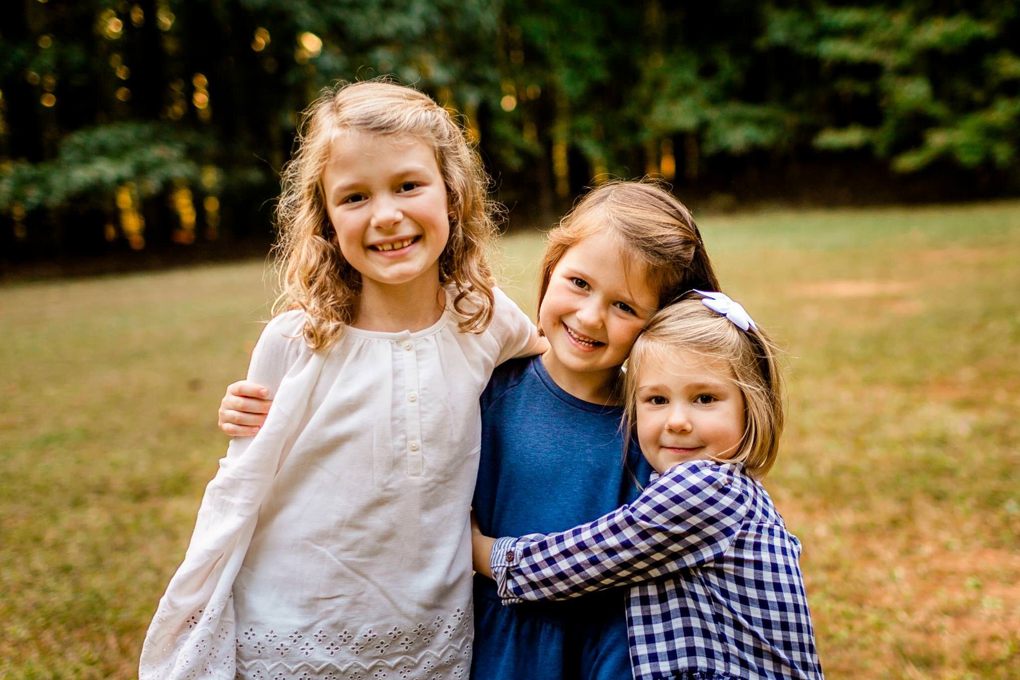 Raleigh Family Photographer | Umstead Park | By G. Lin Photography | Young girls hugging each other