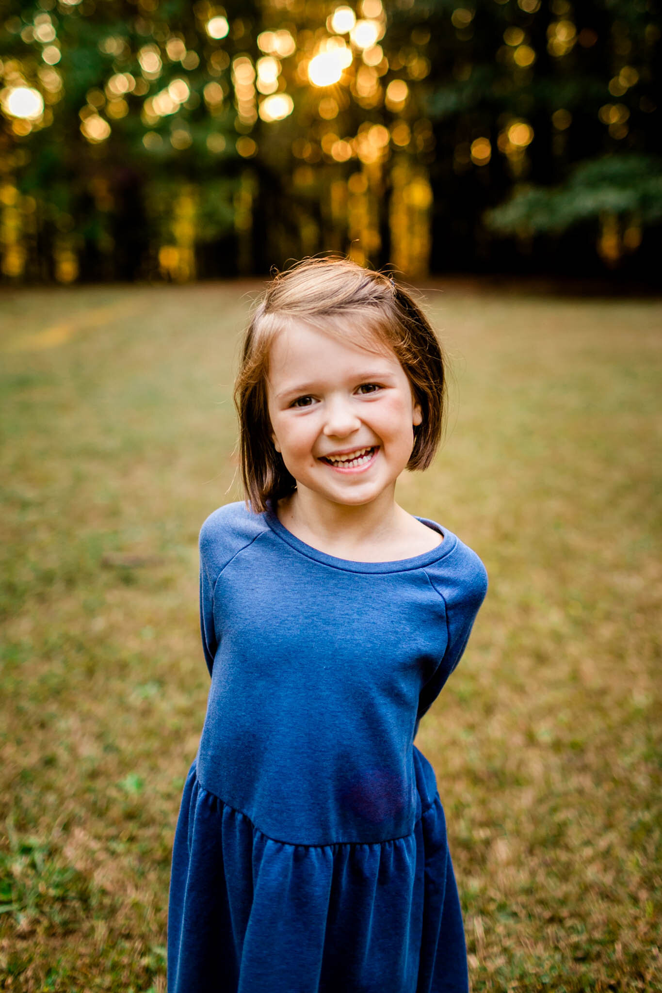 Raleigh Family Photographer | Umstead Park | By G. Lin Photography | Sunset portrait of young girl smiling