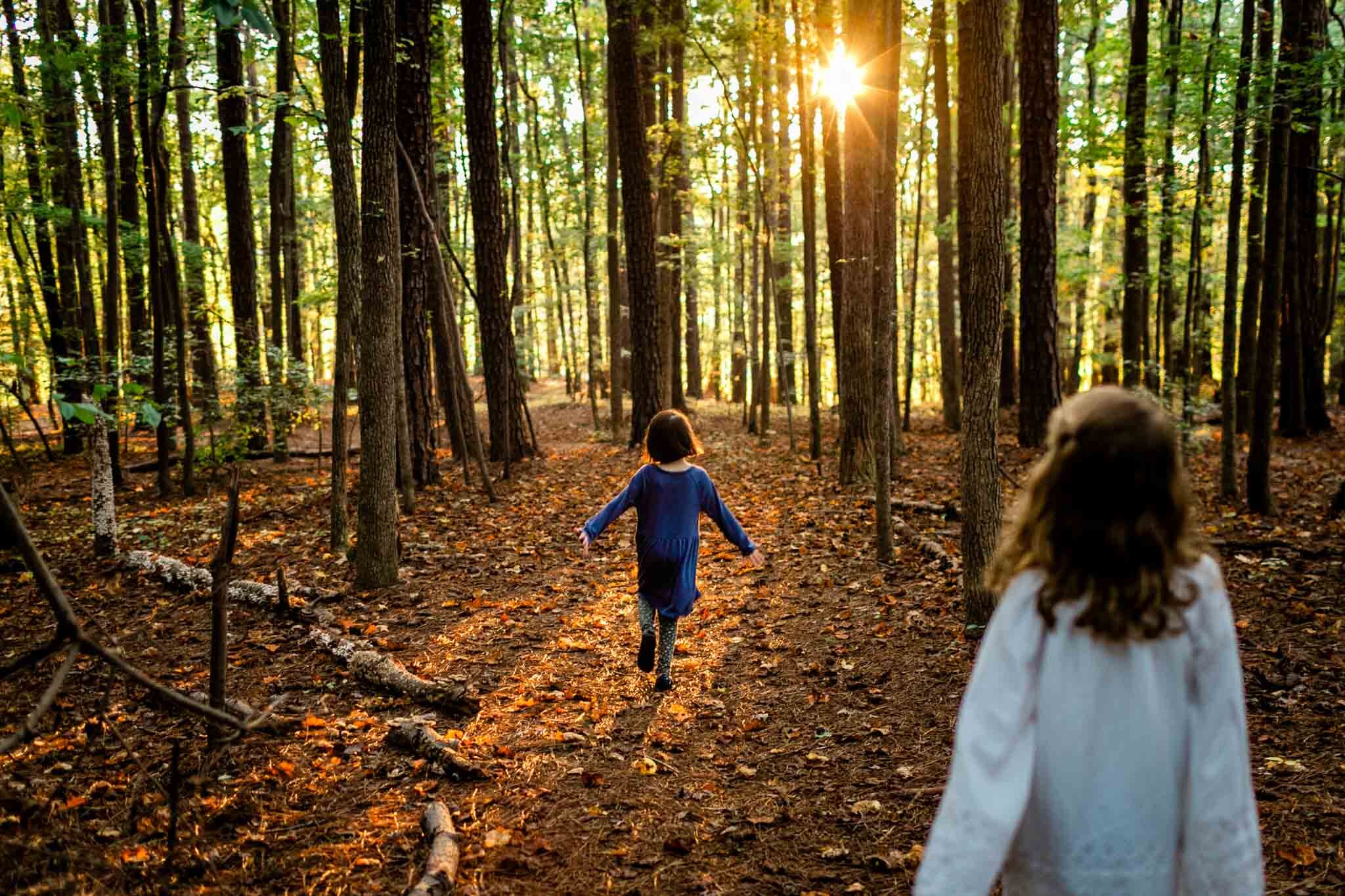 Raleigh Family Photographer | Umstead Park | By G. Lin Photography | Girl running towards sunset in forest
